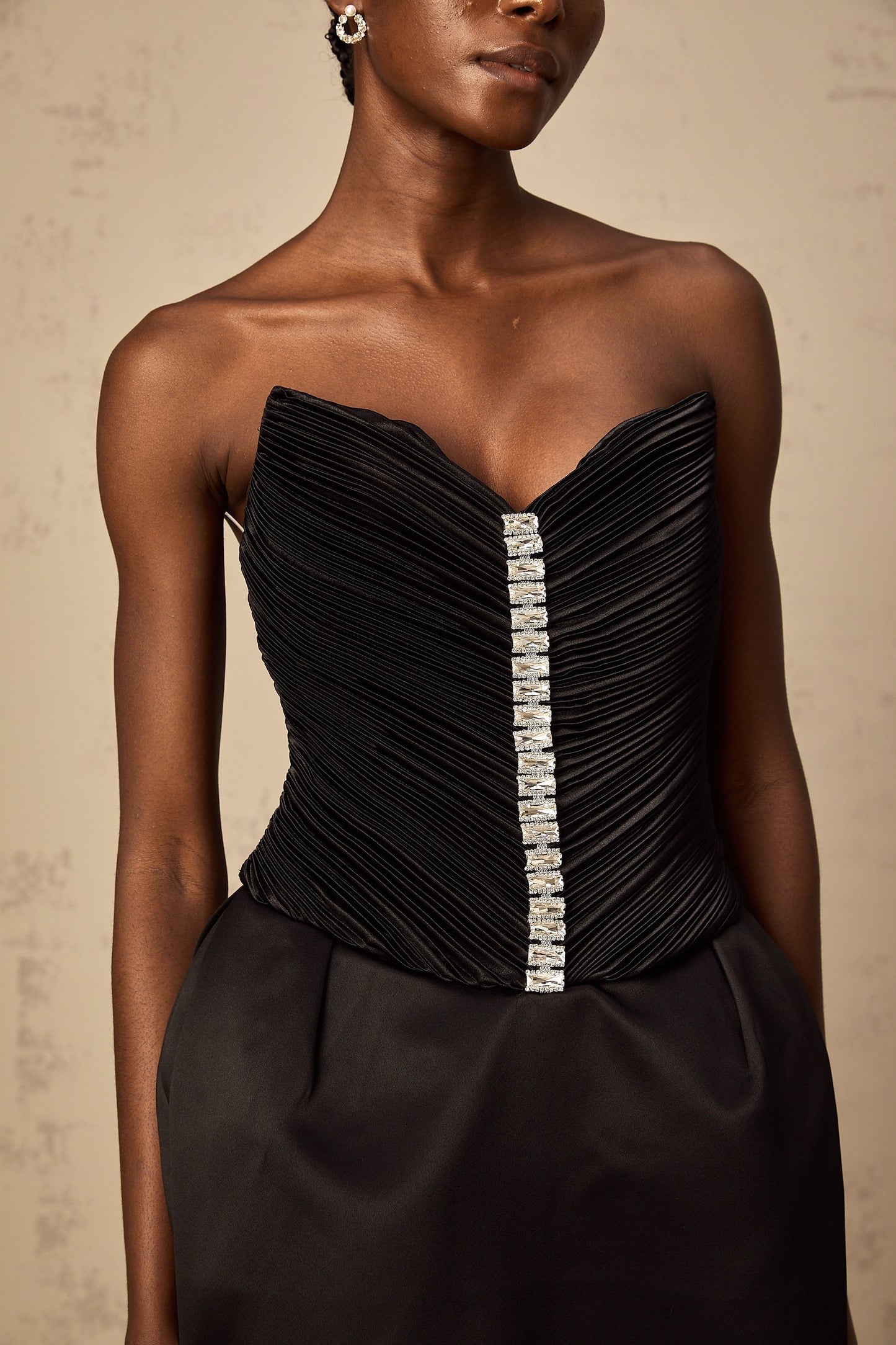 A black mini dress with ruched detailing and puff sleeves named Francis