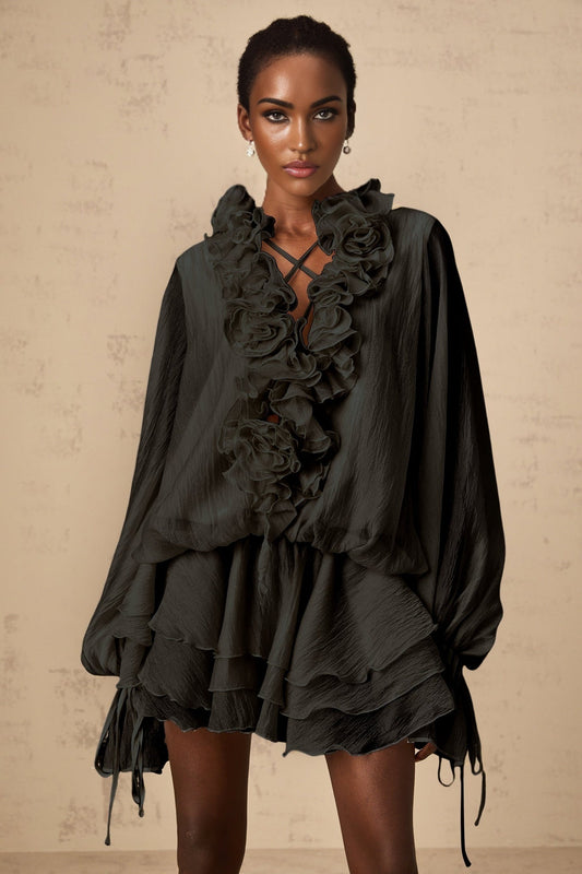 A black mini dress with tiered layers and floral applique details named Zephyrine