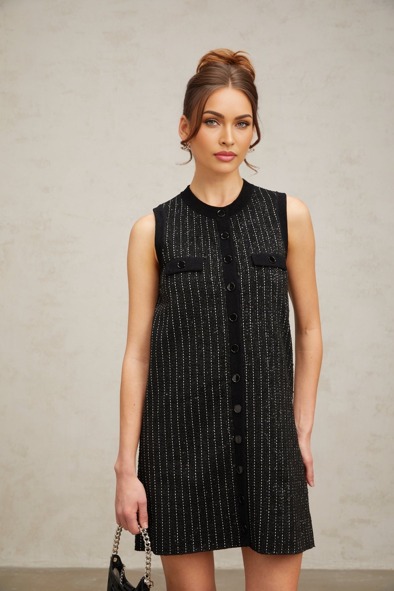 A black mini dress with vertical stripes and sequin embellishments featuring a knit fabric and a design inspired by Zelda
