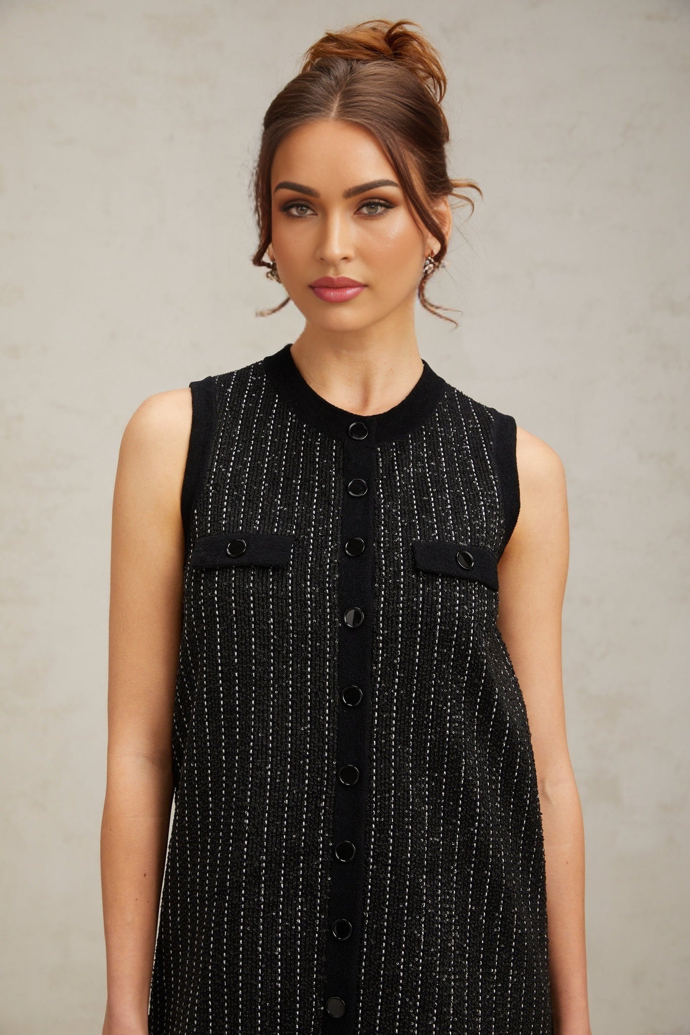 A black mini dress with vertical stripes and sequin embellishments featuring a knit fabric and a design inspired by Zelda