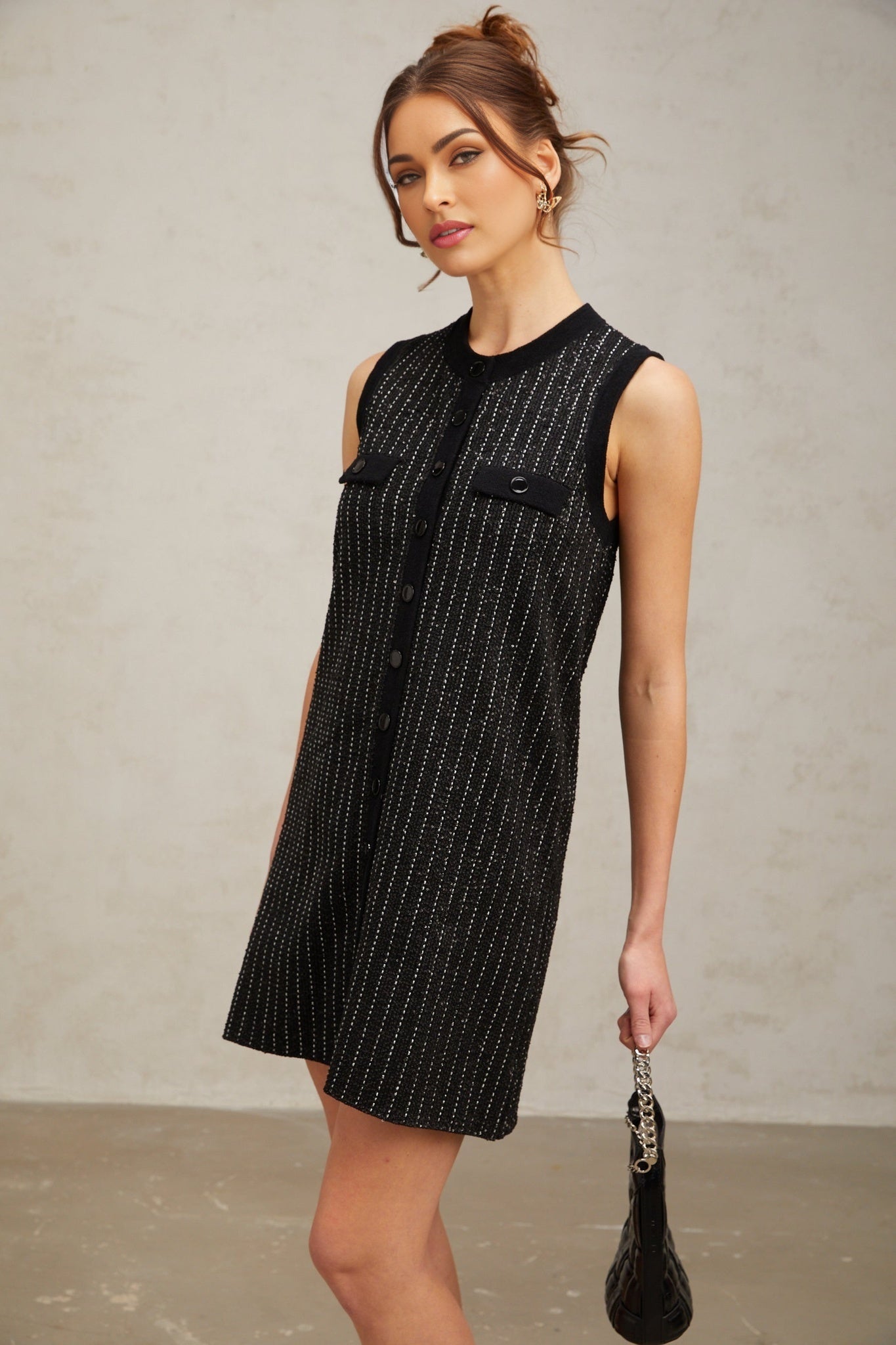 A black mini dress with vertical stripes and sequin embellishments featuring a knit fabric and short length named Zelda