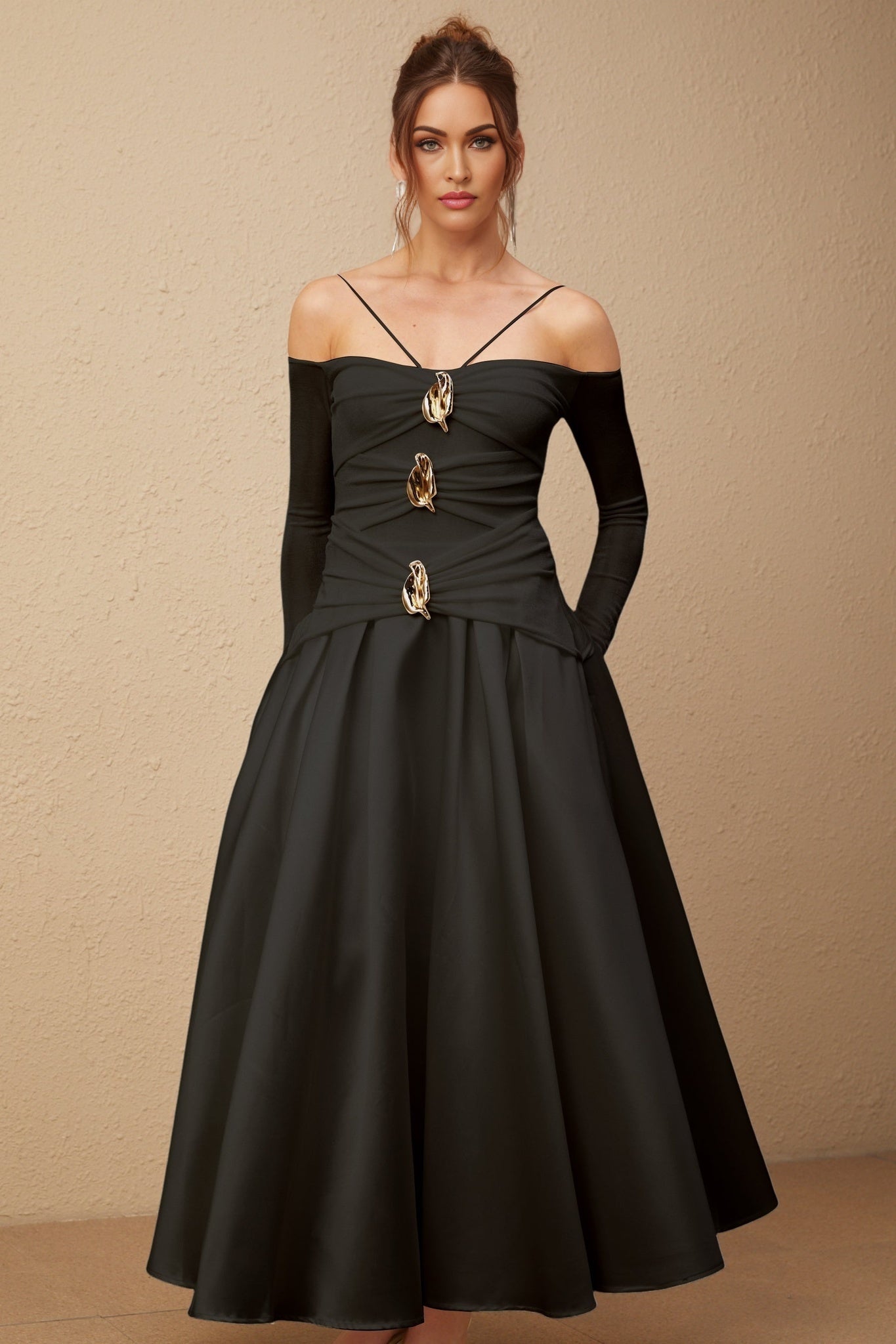 A black offshoulder maxi dress with panelled design worn by a model named Nadine