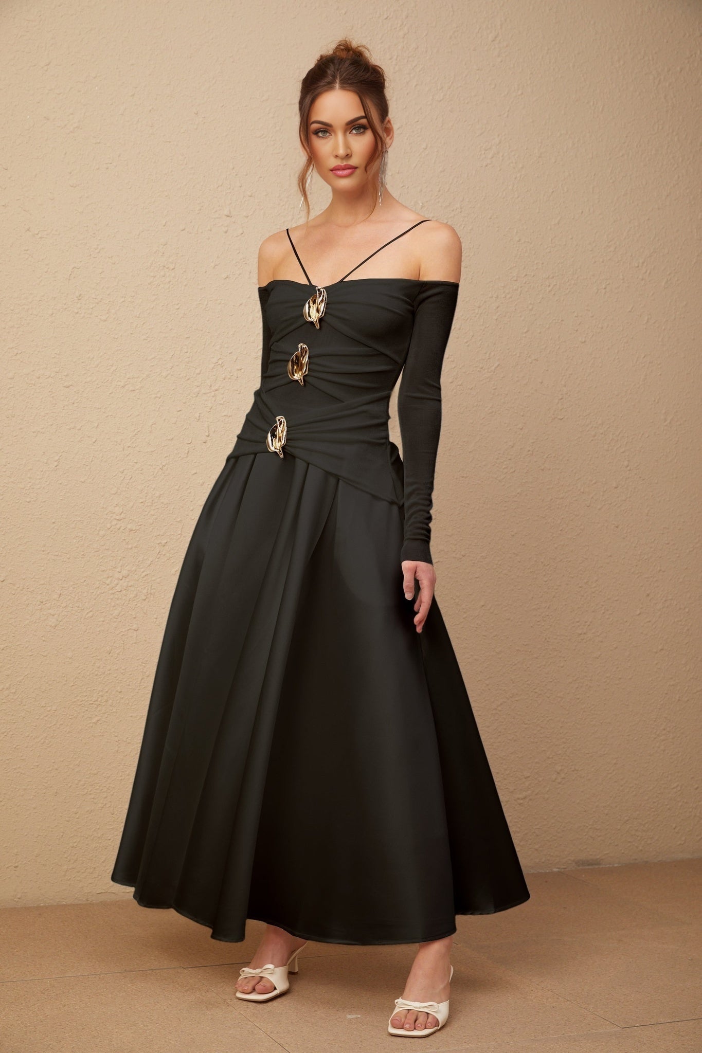 A black offshoulder maxi dress with panelled design worn by a model named Nadine