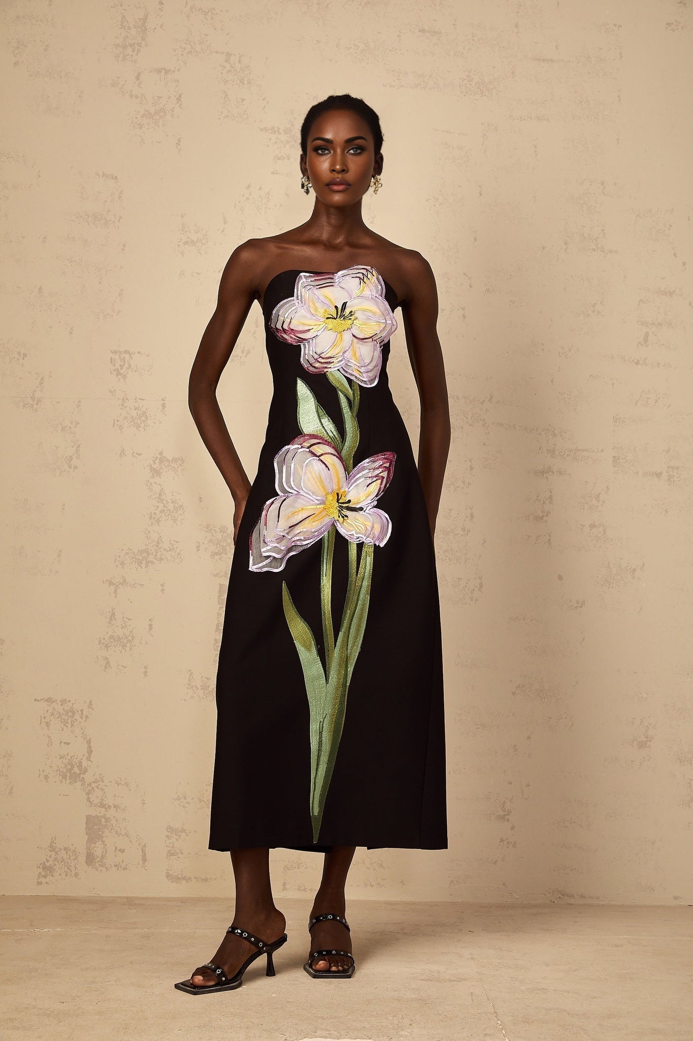 A black offshoulder midi dress with sequin embroidery details named Irene featuring a fitted silhouette and elegant design