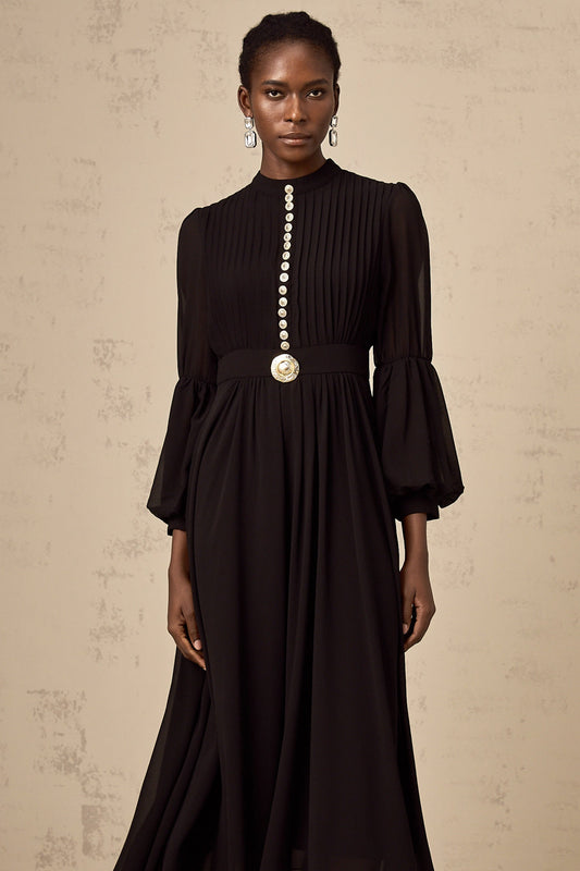 A black pleated midi dress with buttonfront detail and a feminine silhouette named Viviane