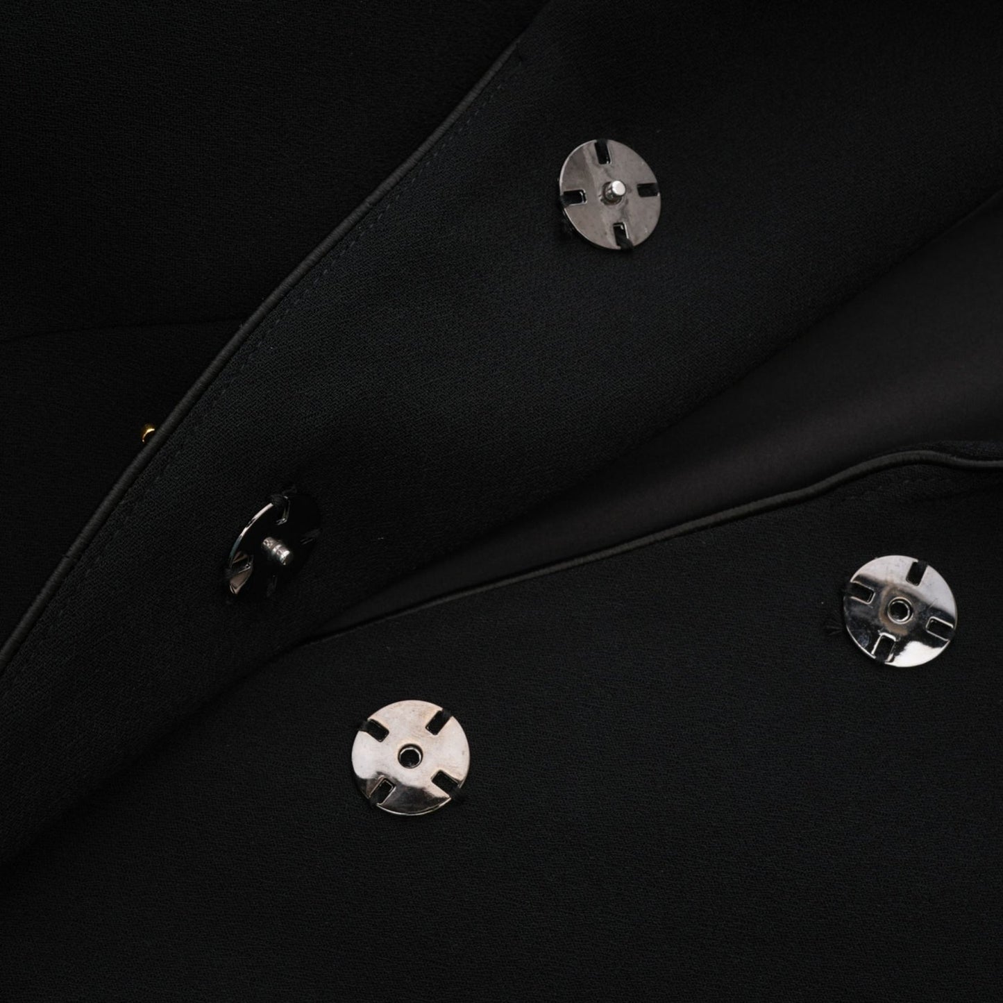 A black single breasted long coat by Aelle