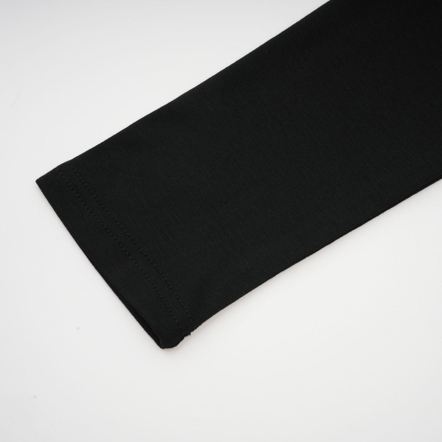 A black sleeveless top with an open front design and gathered fabric details