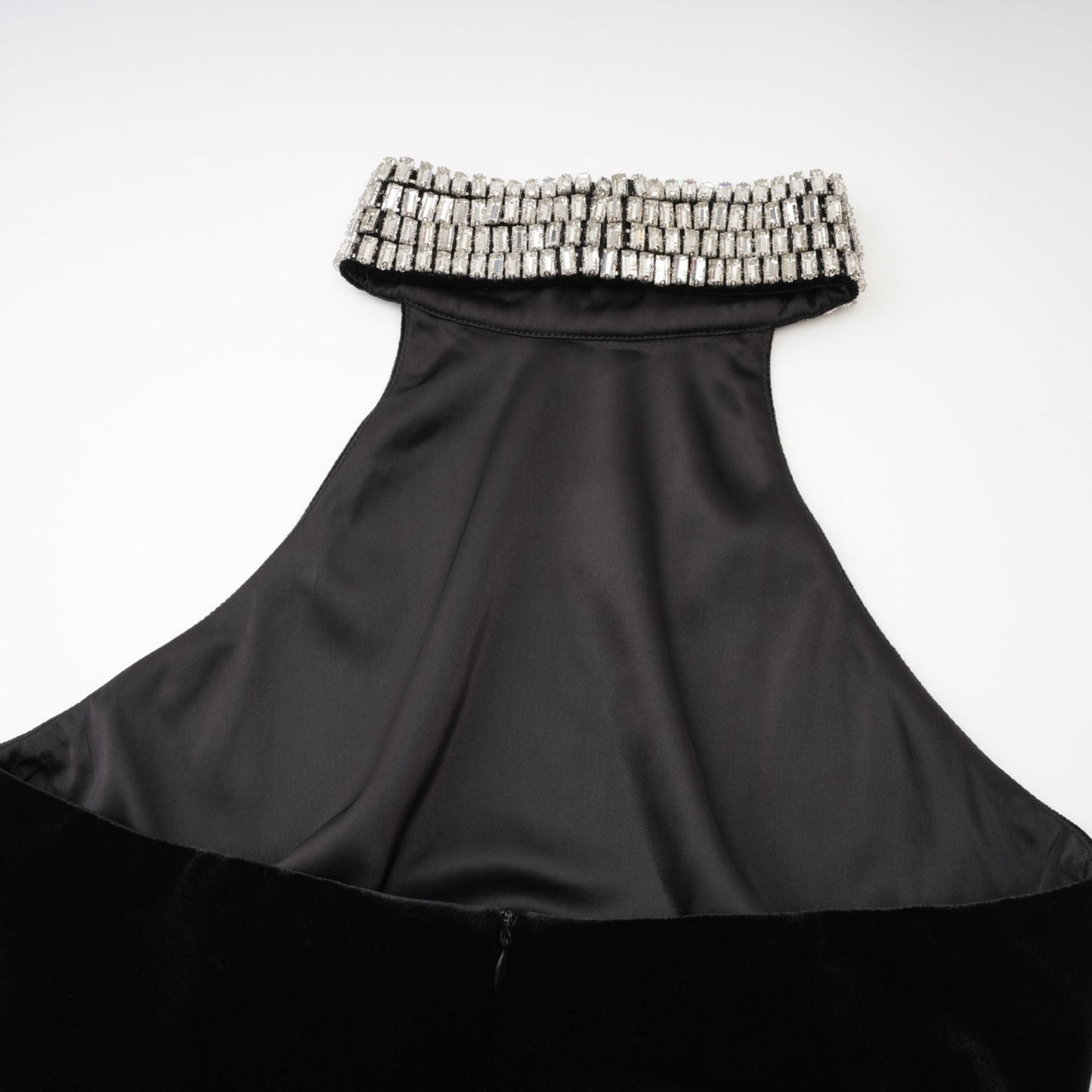Roll neck black dress with crystal embellished turtle neck sleeveless ankle length rear zip fastening and side slit Composed of 100% Polyester