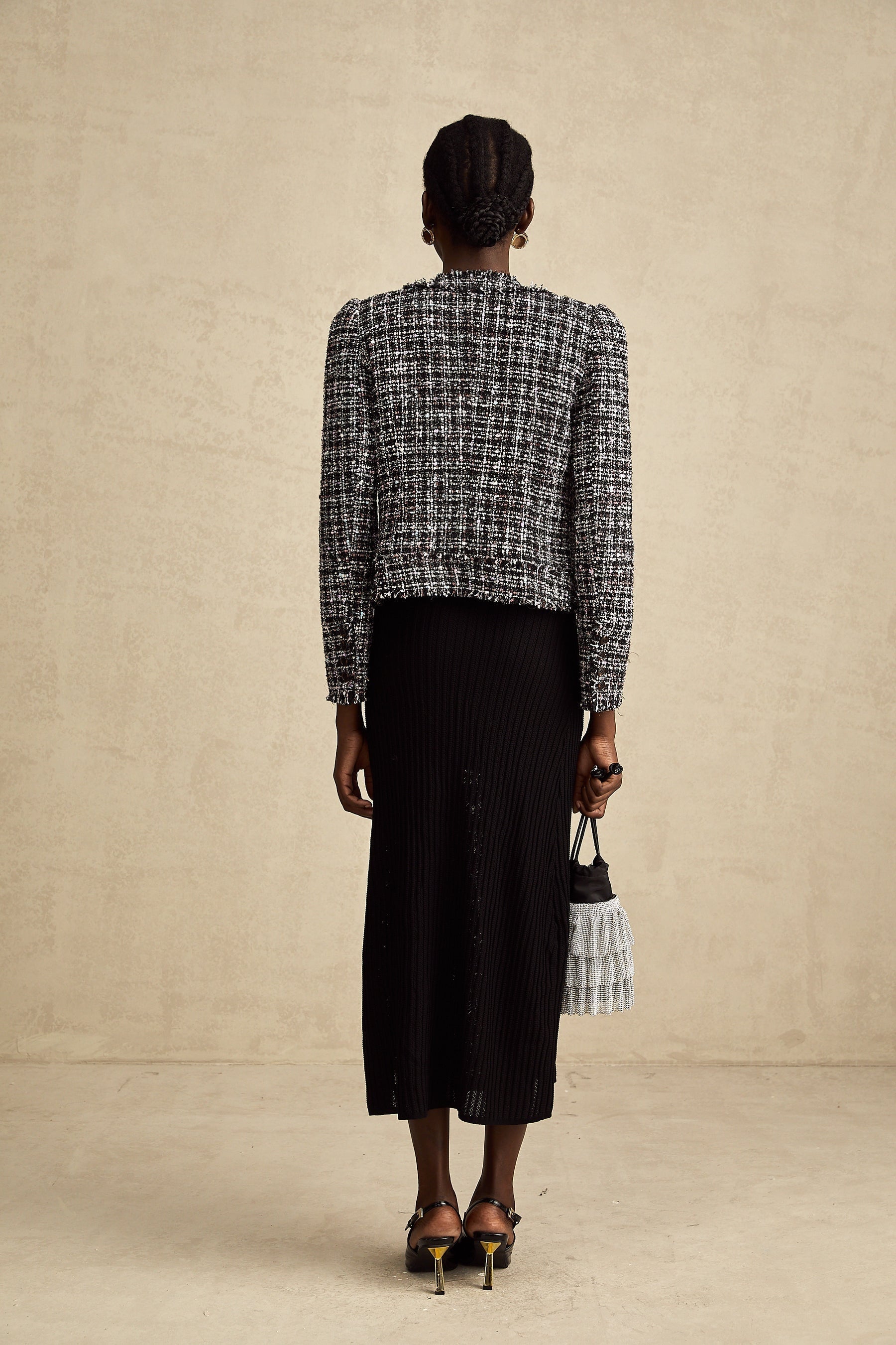 A black tweed jacket with a frayed edge and checkered pattern called Justine