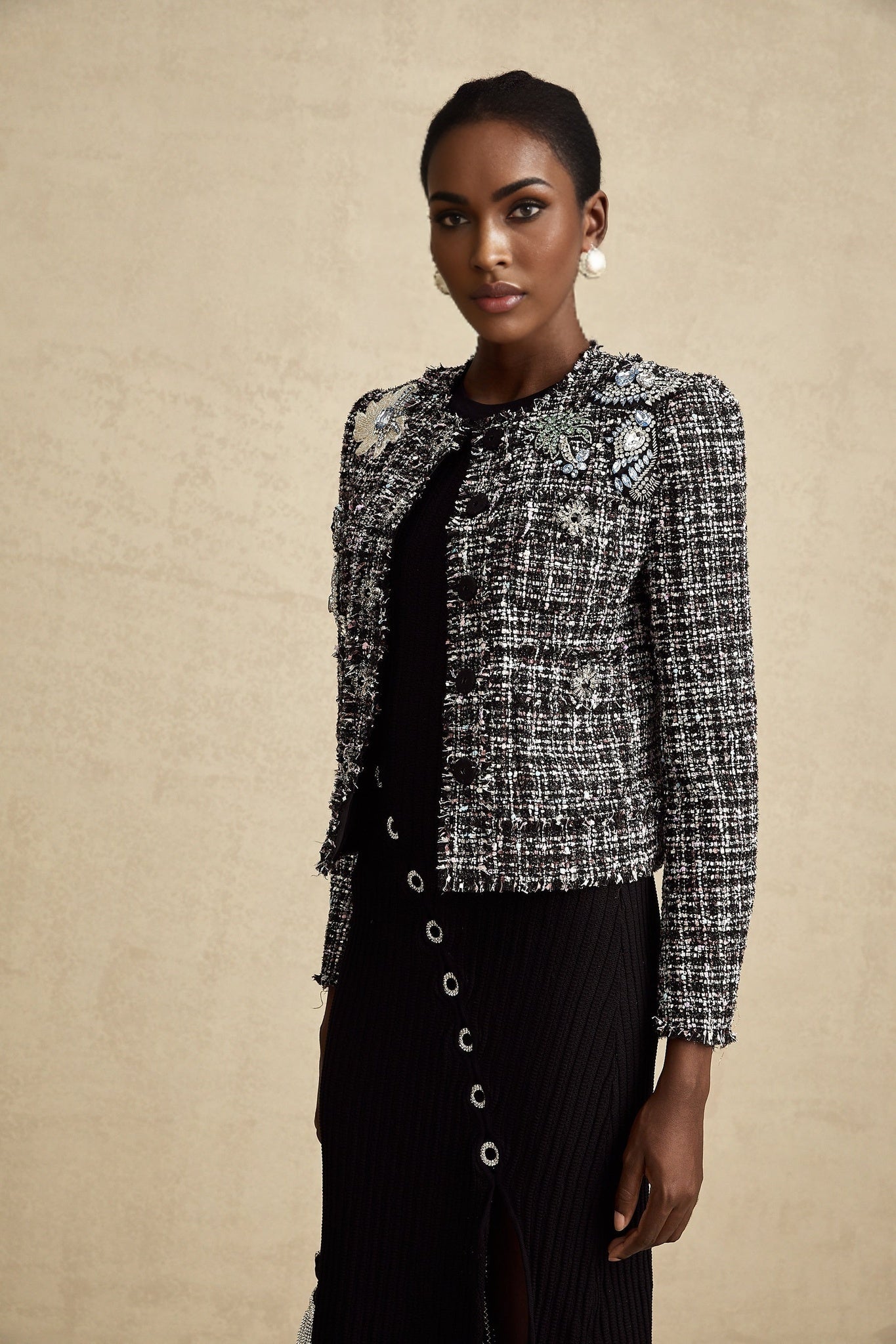 A black tweed jacket with a frayed edge and checkered pattern named Justine