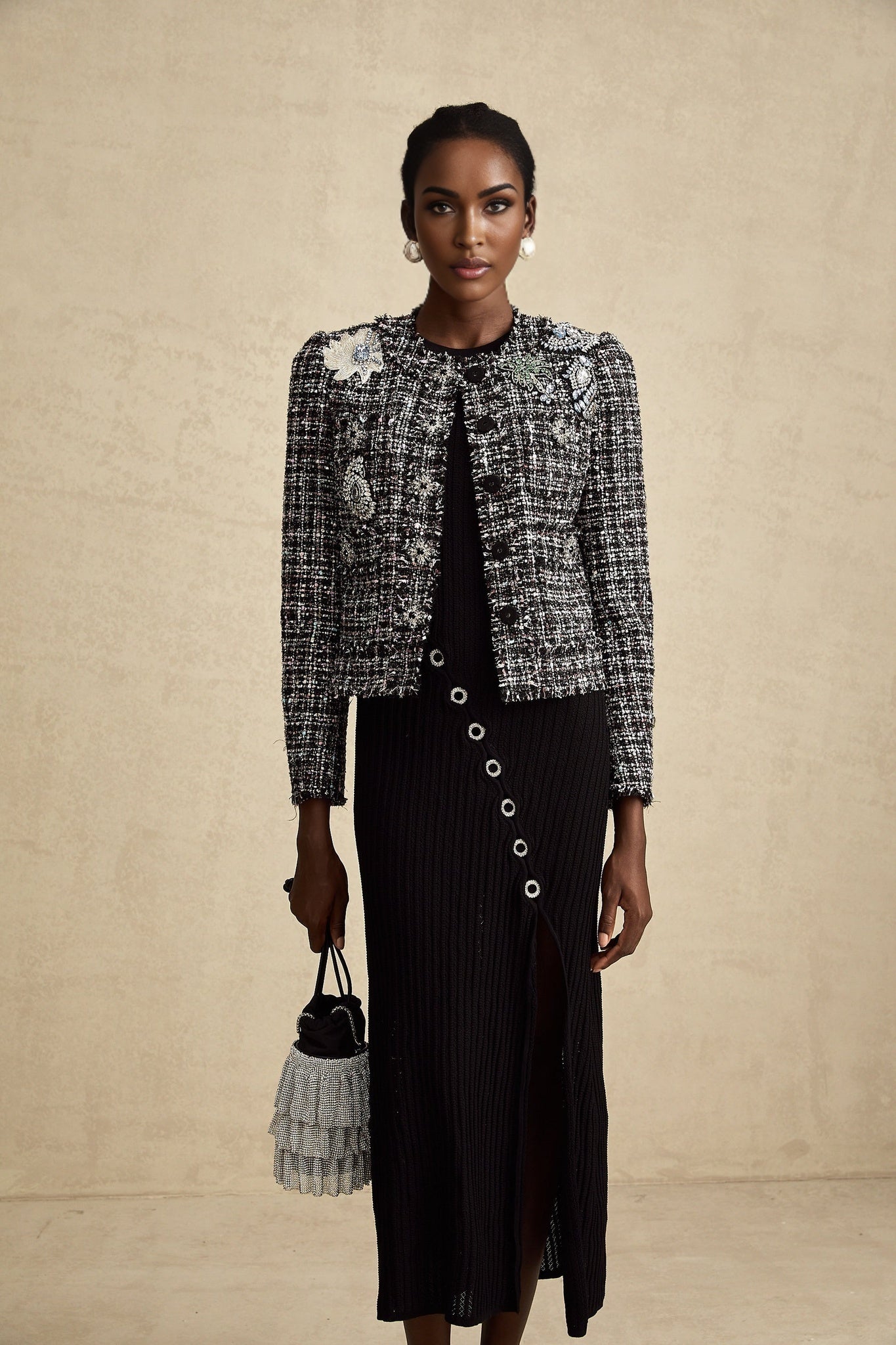 A black tweed jacket with frayed edges and a checkered pattern featuring a classic tailored silhouette named Justine