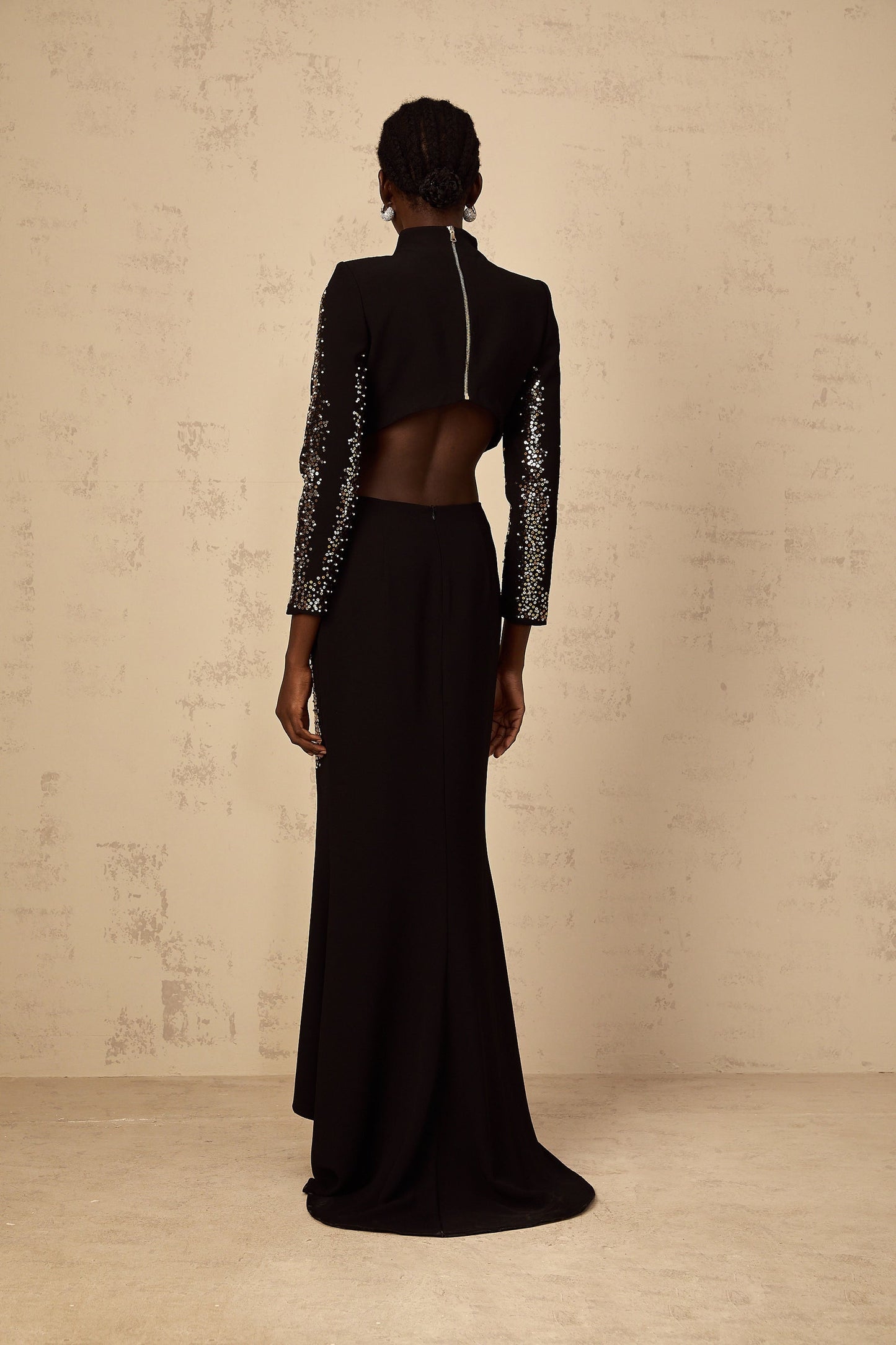 A black twopiece outfit consisting of a sequin embellished top and matching skirt set named Mahault