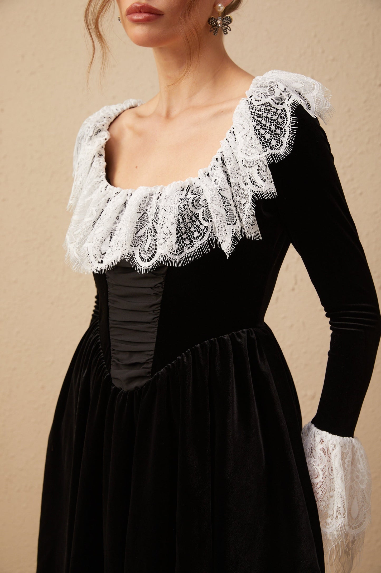 A black velvet mini dress with lace trim details called Fabiana