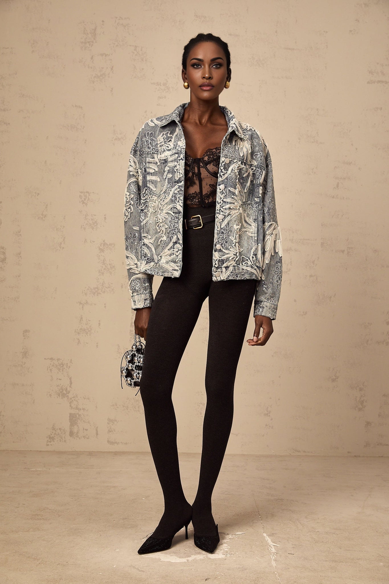 A blue denim jacket with sequined flower embroidery featuring a design called Mailys