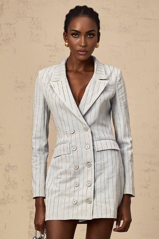 A blue denim mini dress with rhinestone embellishments styled as a blazer featuring a fitted silhouette and short length