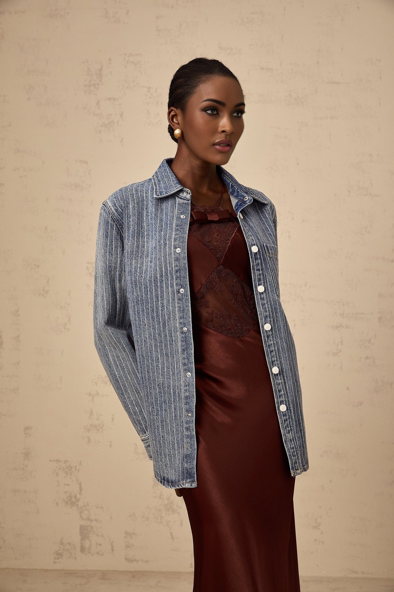 A blue denim shirt with vertical stripes and embellishments featuring a design called Josephine