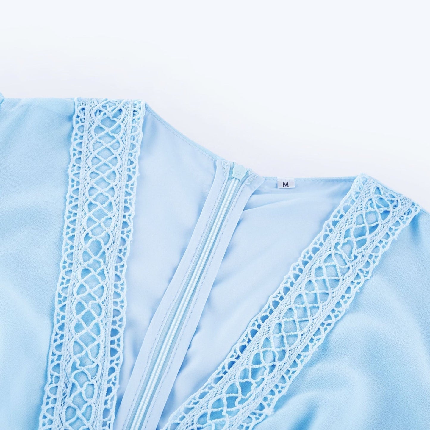 A blue maxi dress with cutouts and ruffles called Juno