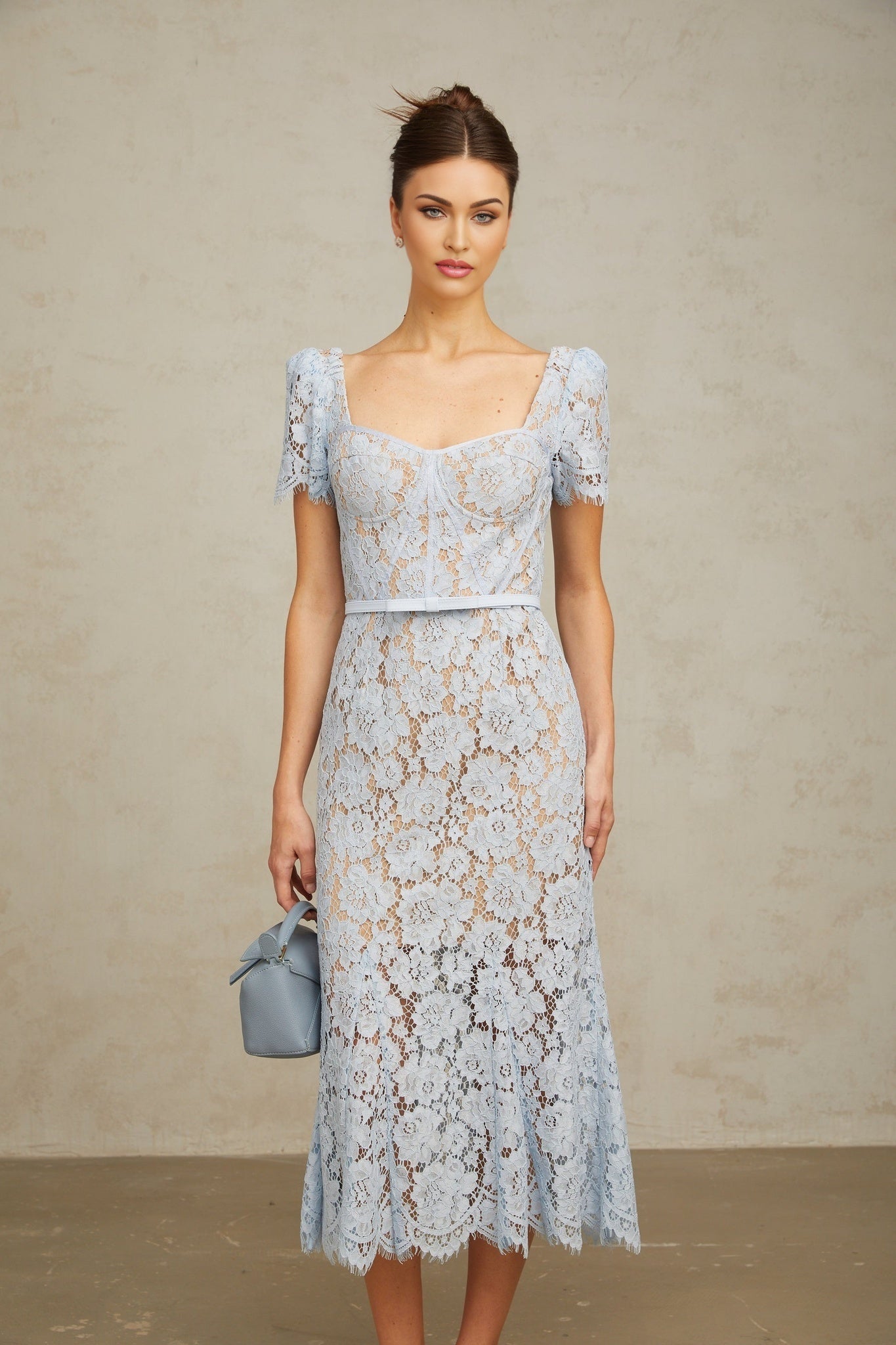A blue midi dress with floral lace pattern and boned bodice named Audrey