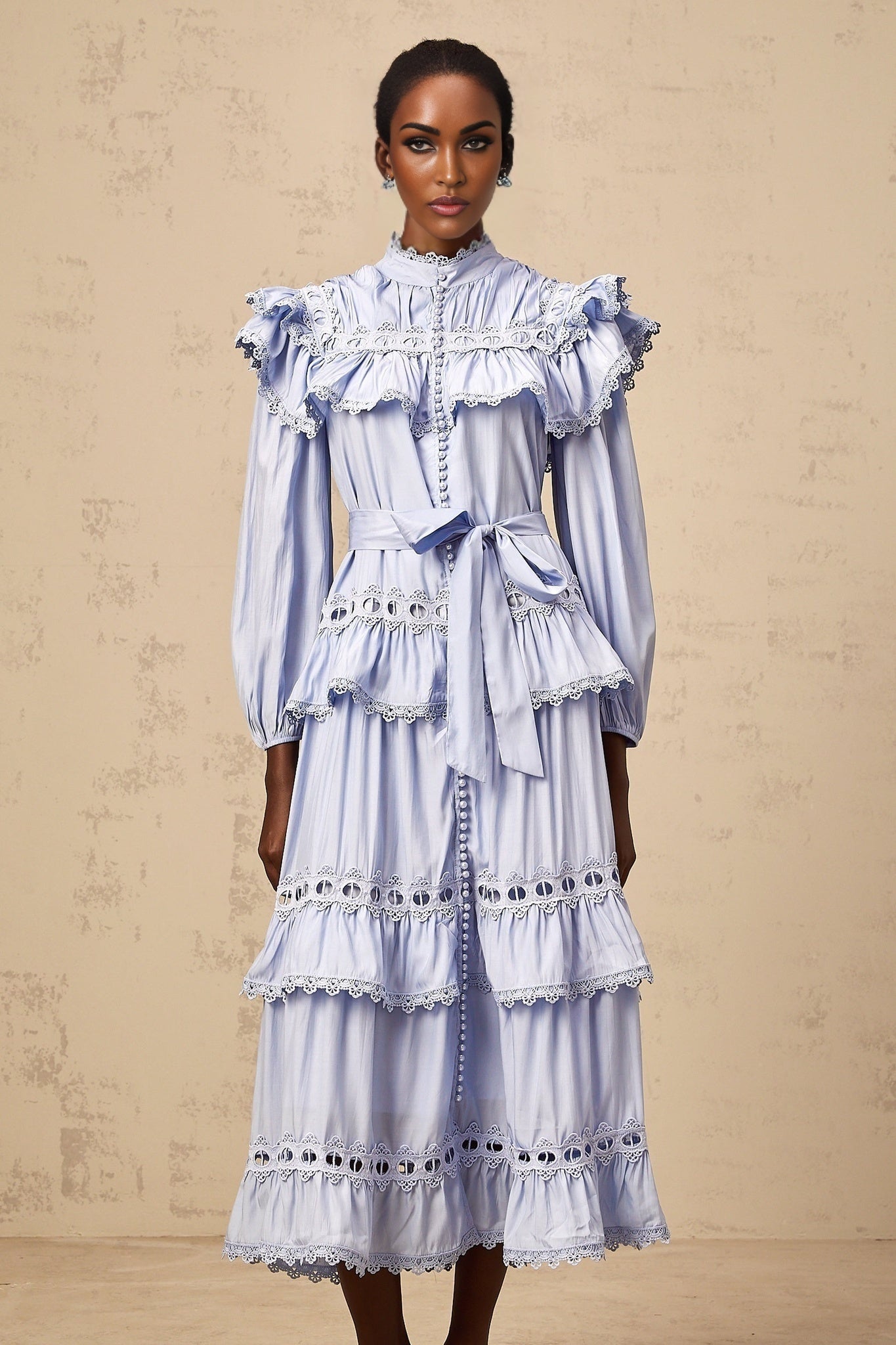 A blue midi dress with tiered layers and lace trim details named Veronique