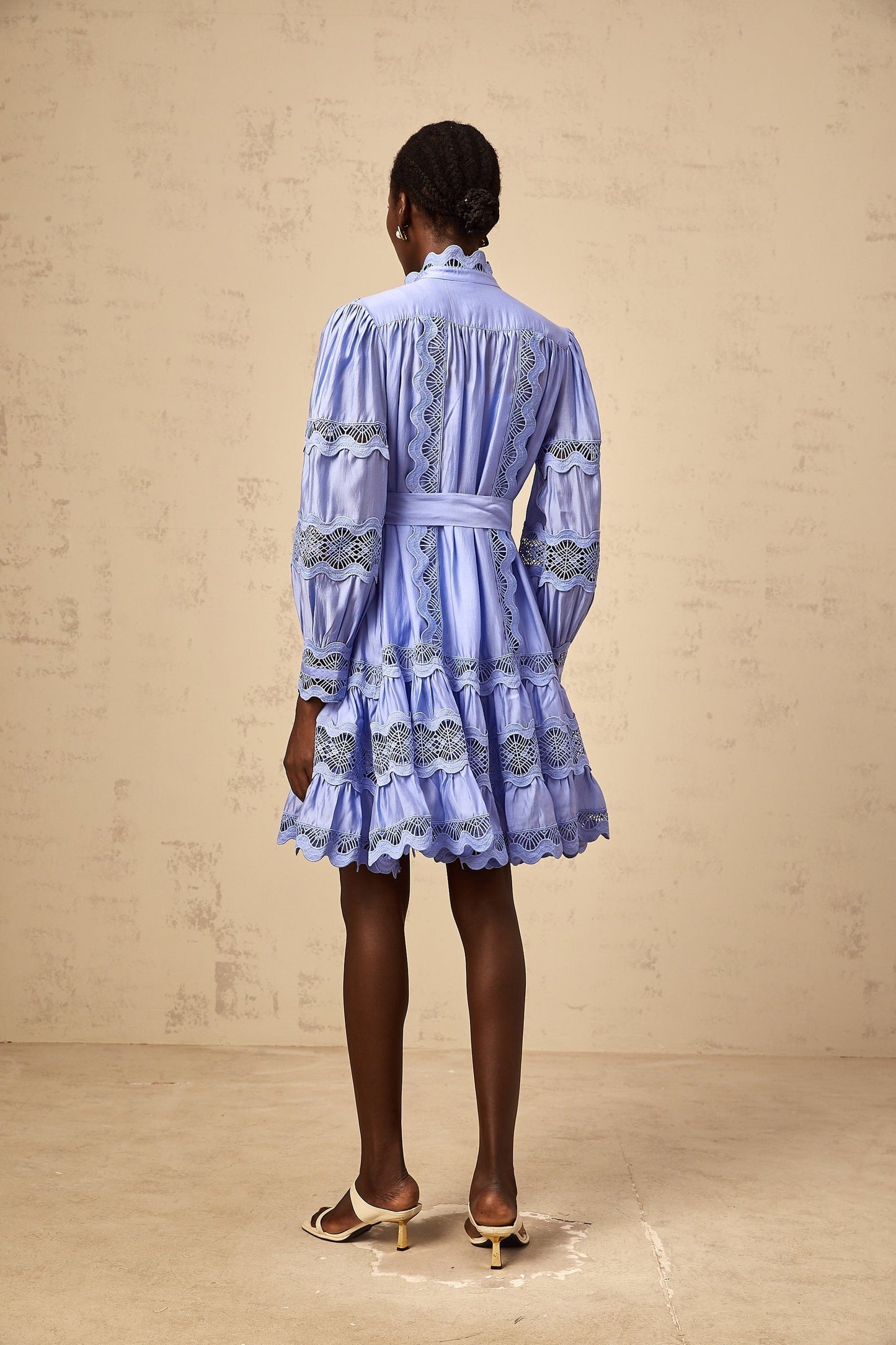 A blue mini dress with tiered layers and cut out embroidery details featuring a floral motif design Poema brand