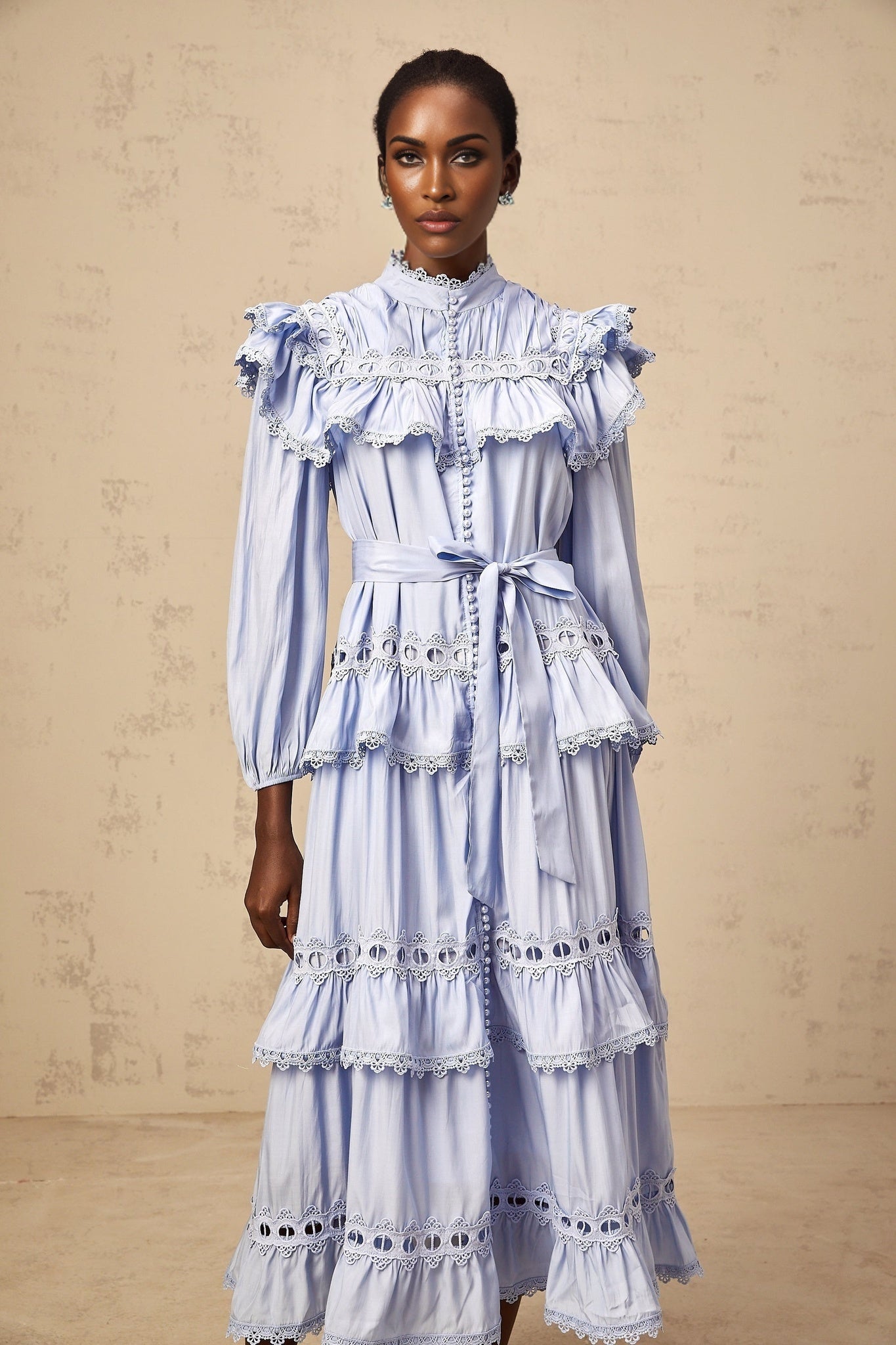 A blue tiered midi dress with lace trim details named Veronique