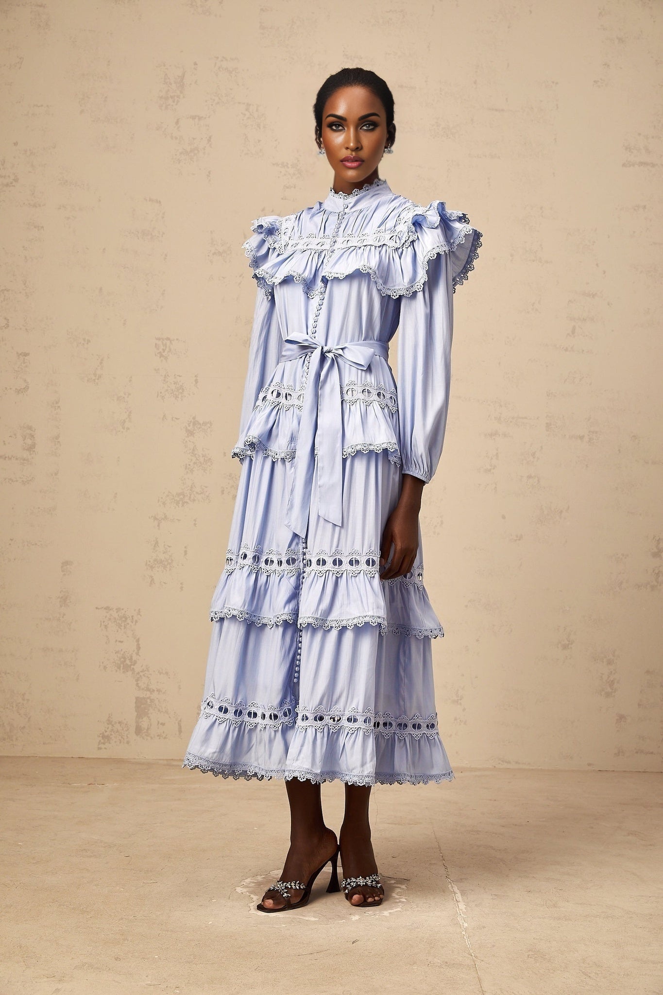 A blue tiered midi dress with lace trim details named Veronique