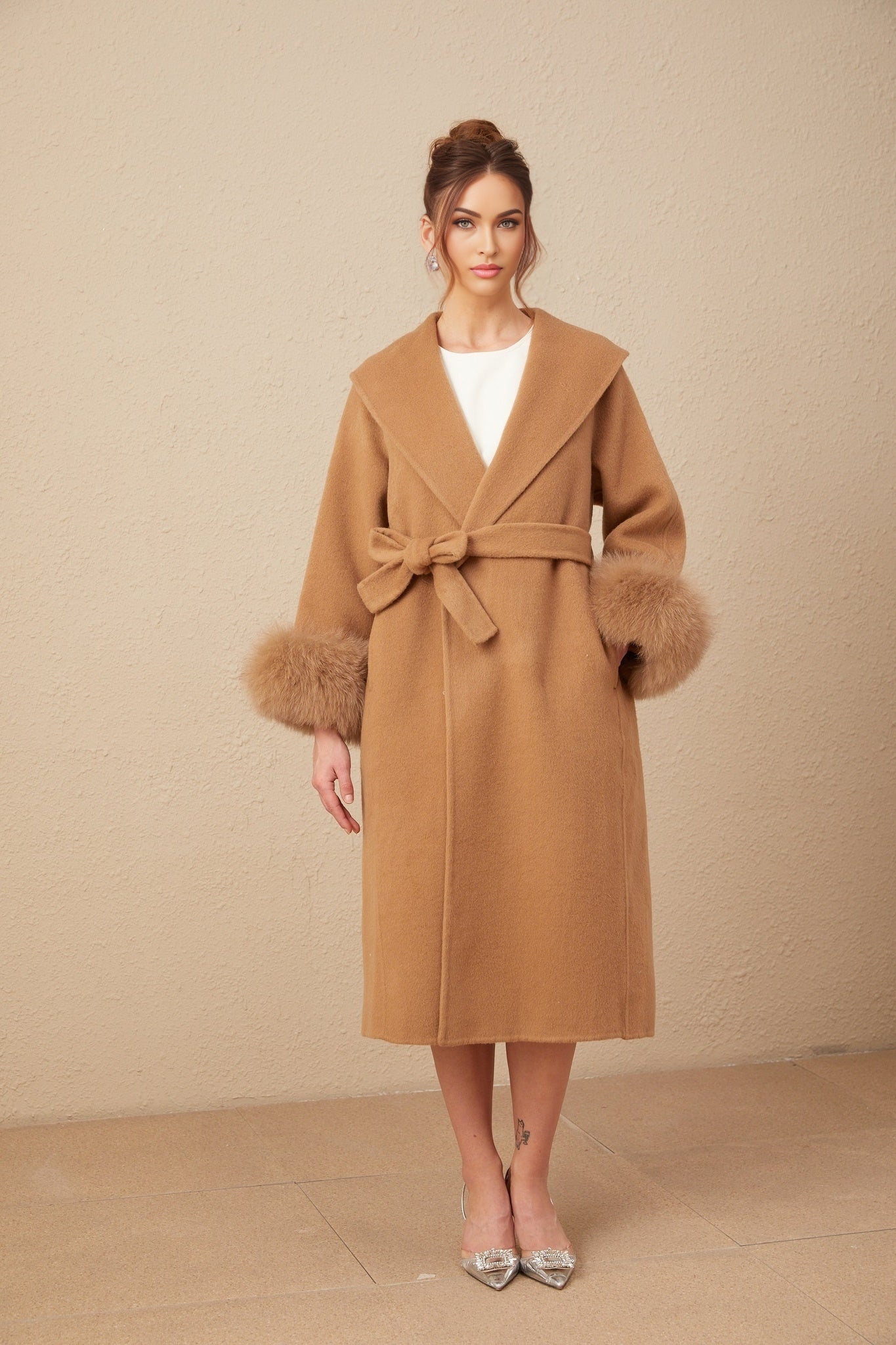A brown felted wool wrap overcoat with a long silhouette and open front design