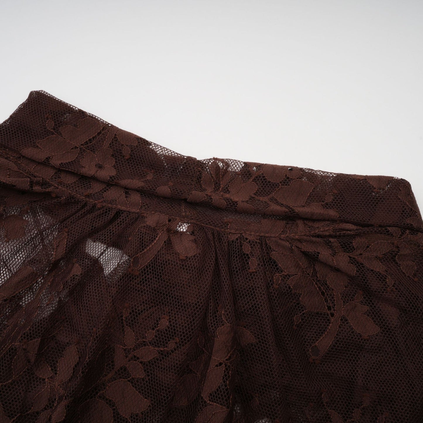 A brown flared midi dress made of chantilly lace named Sylvie with delicate floral patterns and a flattering silhouette