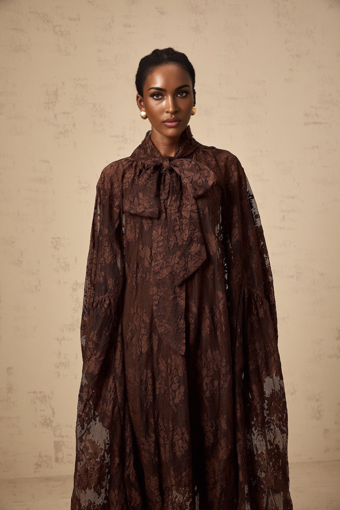 A brown midi dress with a flared skirt made of chantilly lace named Sylvie