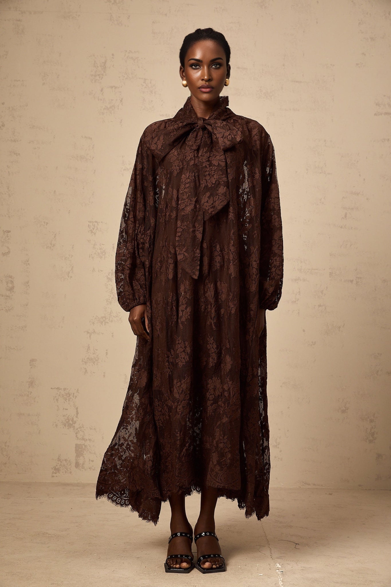 A brown midi dress with flared skirt made of chantilly lace called Sylvie