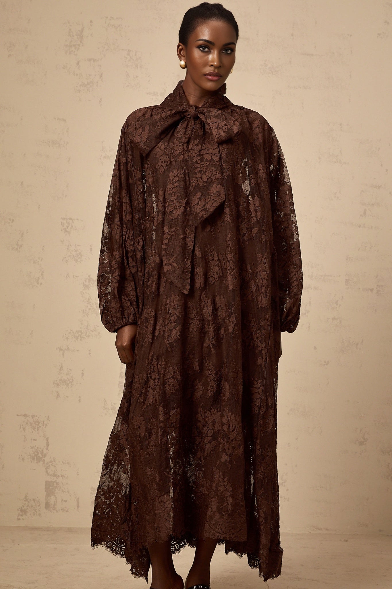 A brown midi dress with flared skirt made of chantilly lace called Sylvie