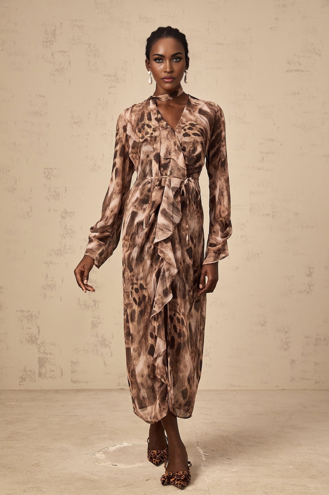 A brown midi dress with leopard print pattern and ruffled details named Sidonie