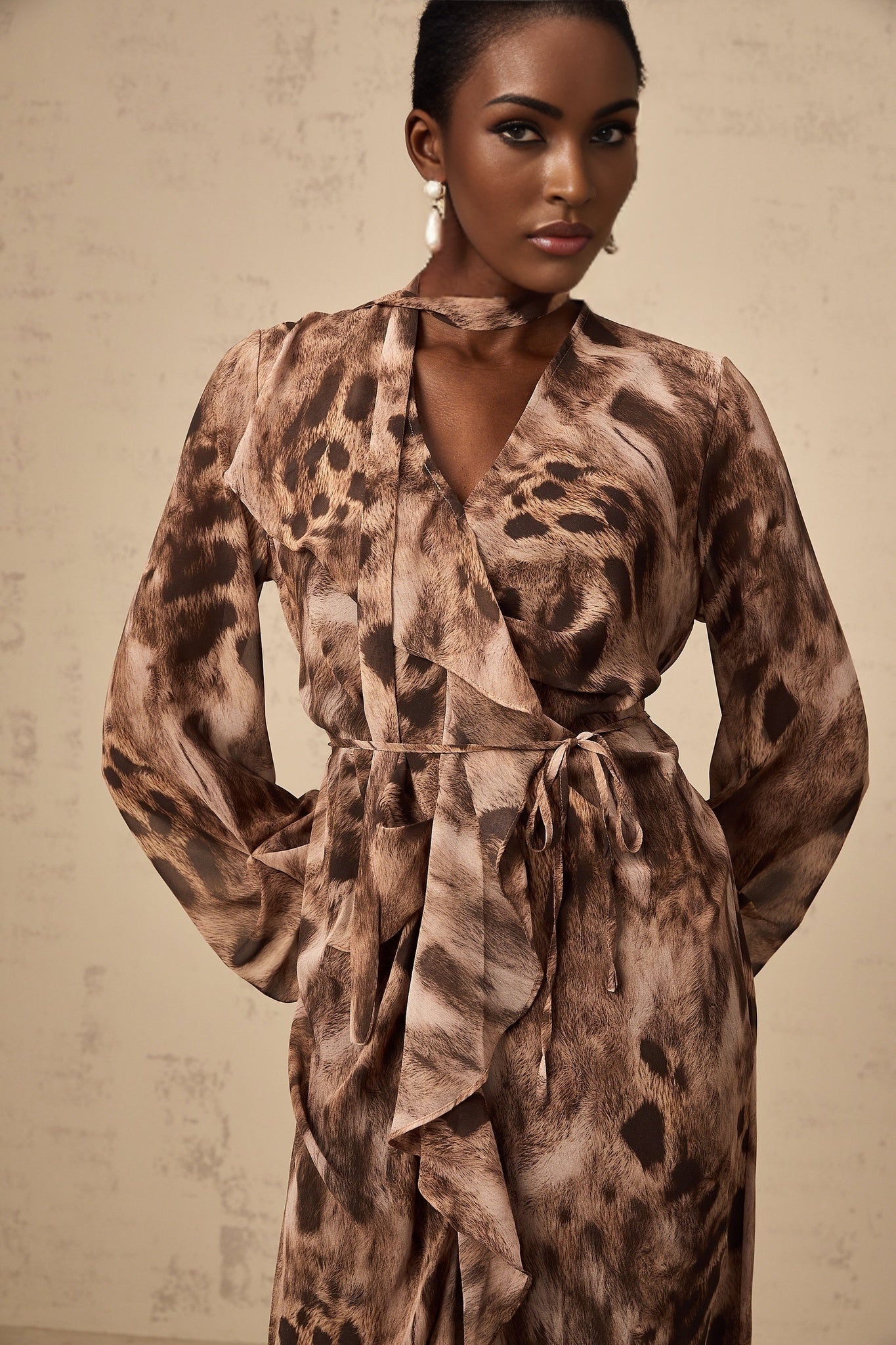 A brown midi dress with leopard print pattern and ruffled details named Sidonie