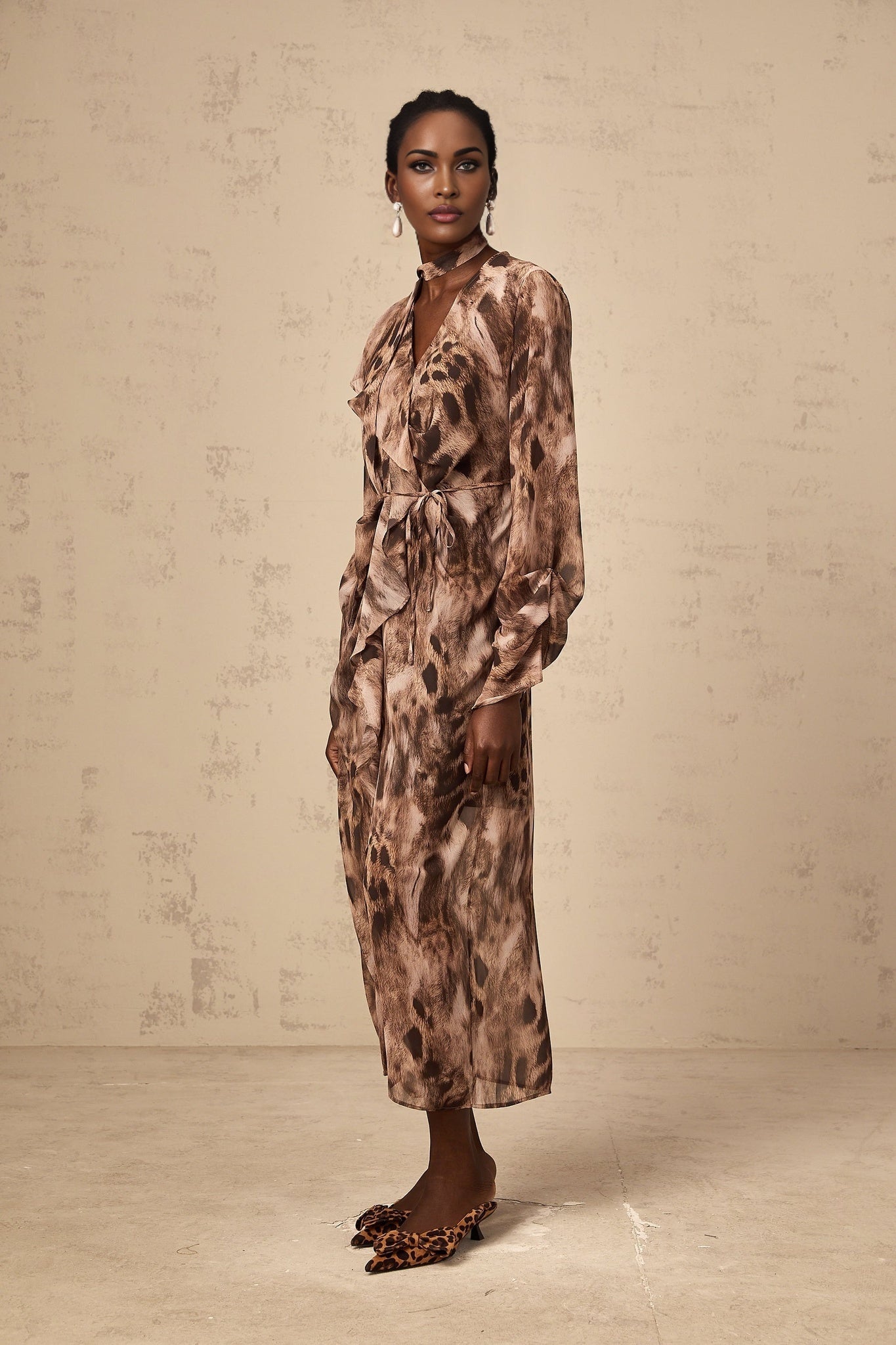 A brown midi dress with leopard print pattern and ruffled details named Sidonie
