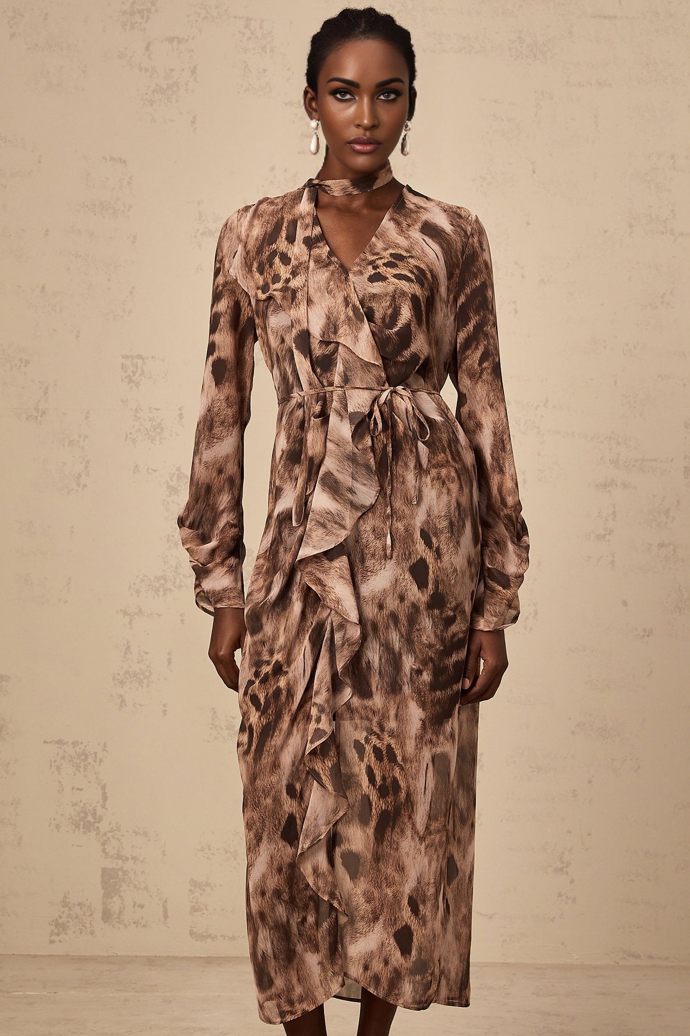 A brown midi dress with ruffled details and leopard print pattern
