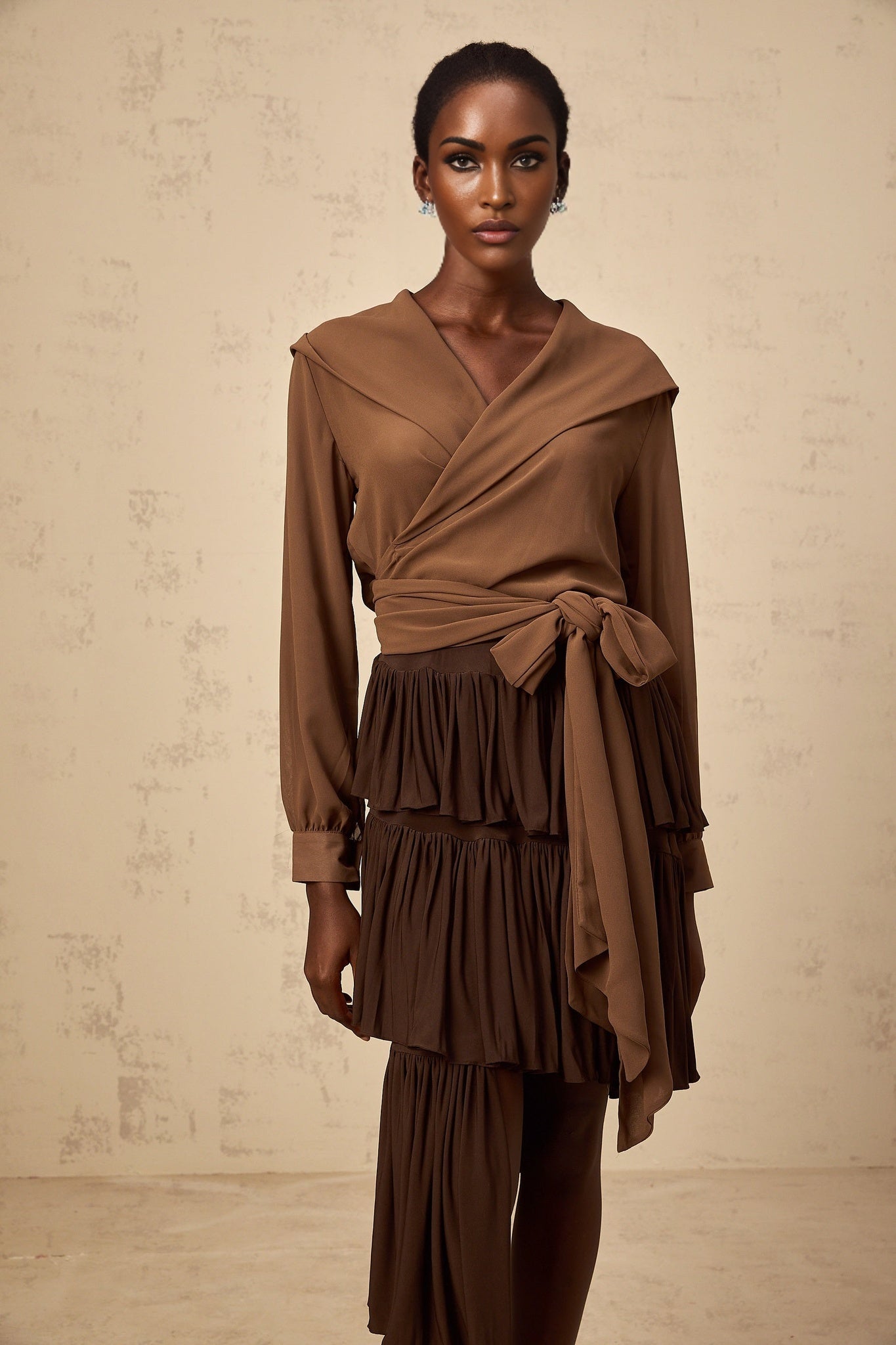 A brown semisheer hooded wrap top with long sleeves and a loose fit named Amandine
