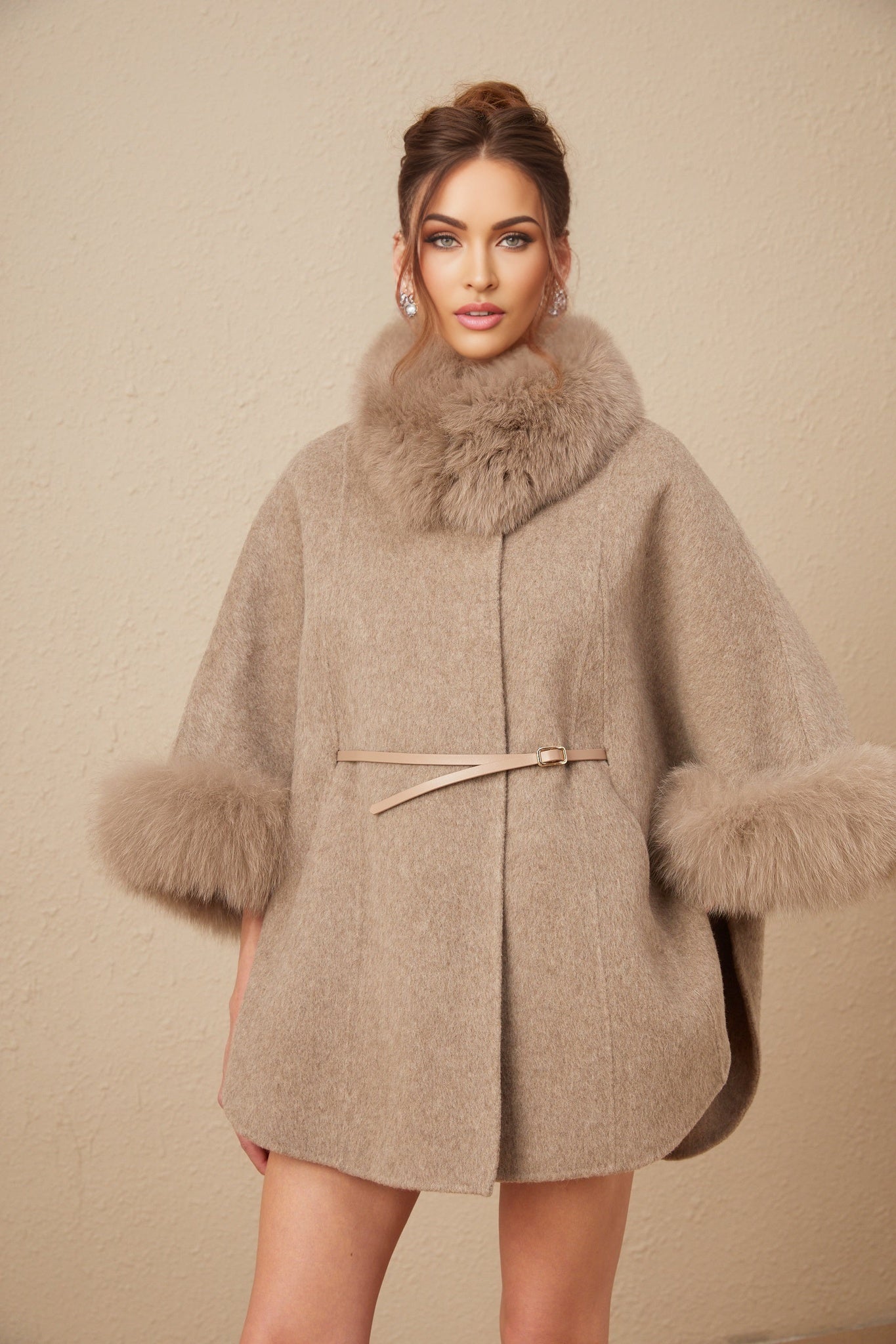 A brown wool cape coat with fur trim and a belt cinching the waist