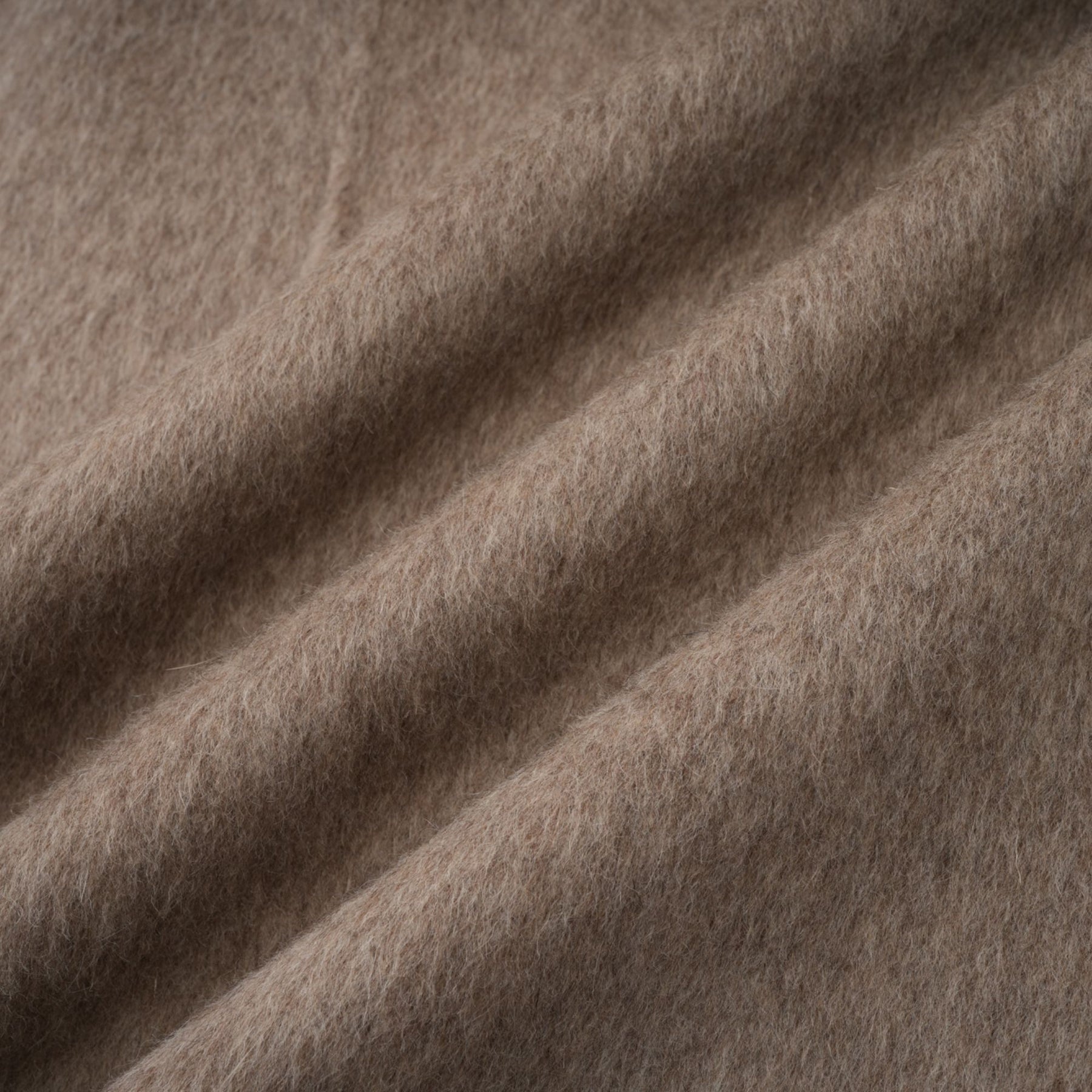 A brown wool cape coat with fur trim and belt cinched at the waist