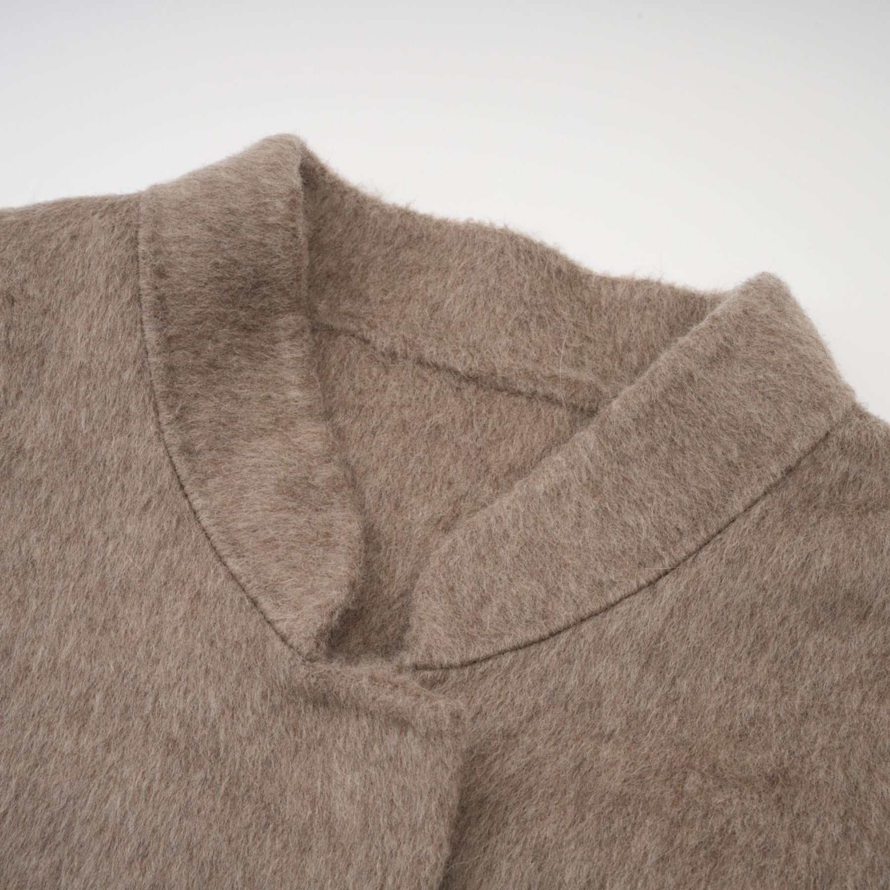 A brown wool cape coat with fur trim and belt cinched at the waist