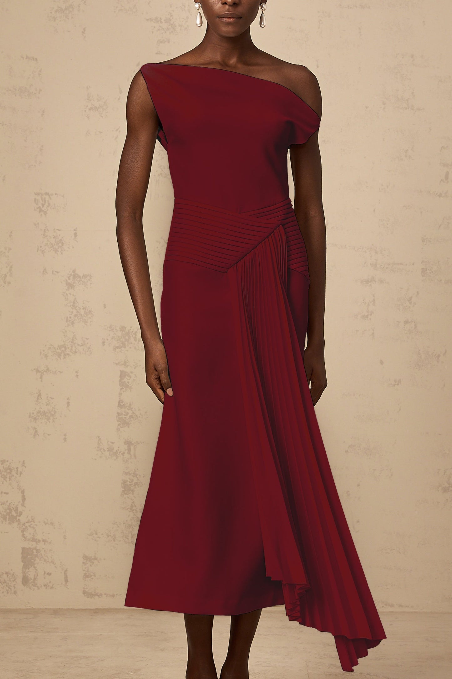 A burgundy asymmetrical midi dress with draped fabric details worn by a model standing against a plain background