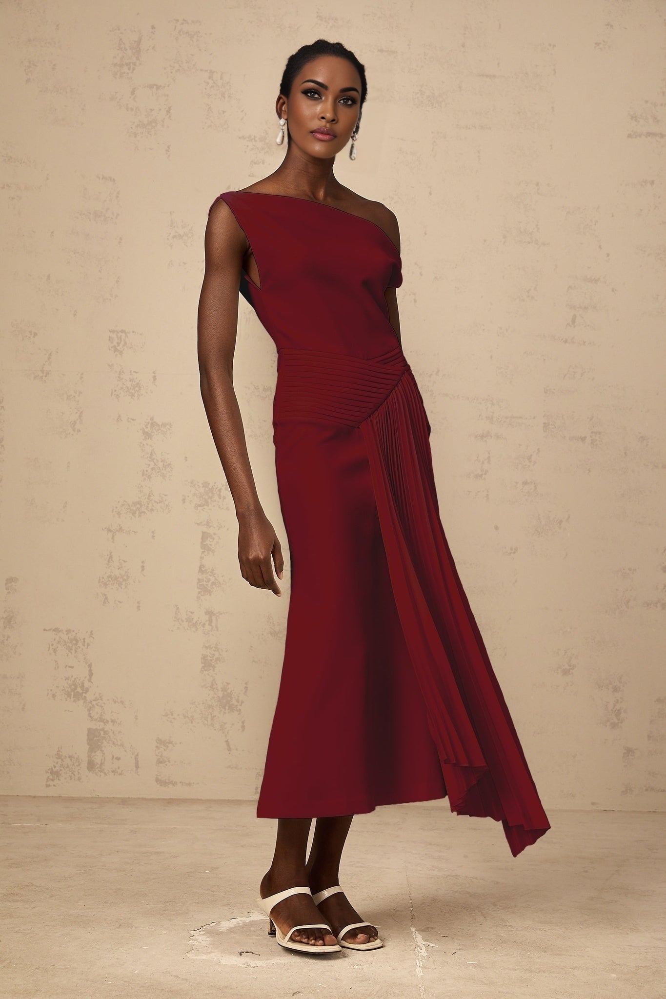 A burgundy colored asymmetrical midi dress with draped detailing featuring a sleek and elegant design