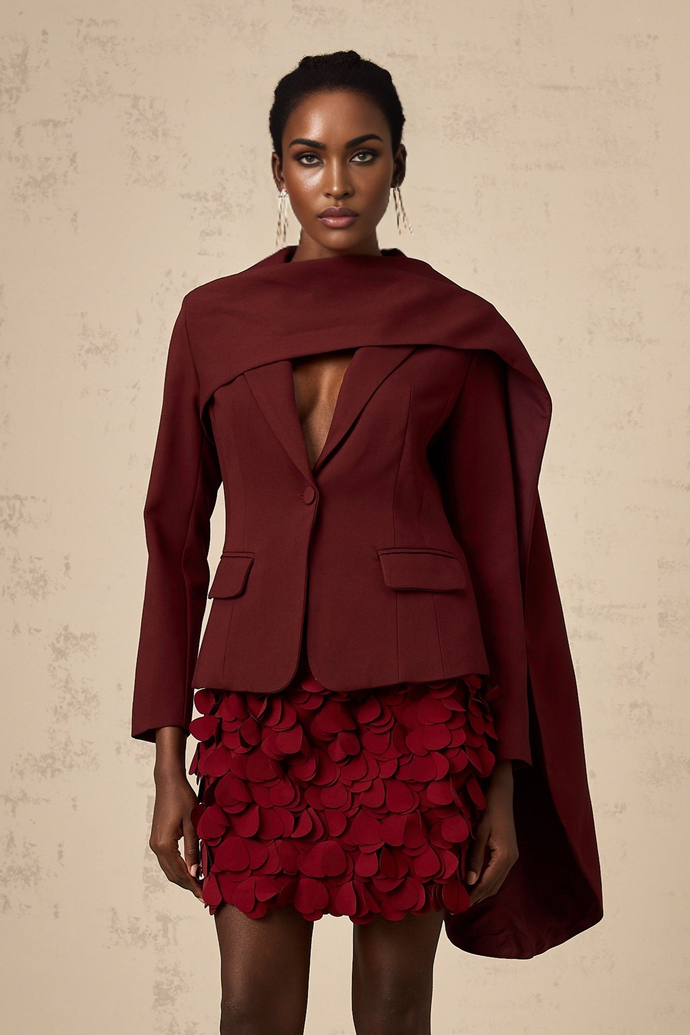 A burgundy colored jacket with a shawl collar and draped front detail named Coralie in a deep wine shade