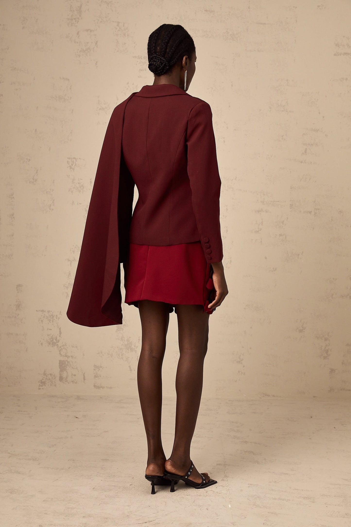 A burgundy colored jacket with shawllike detailing called Coralie in a deep wine shade