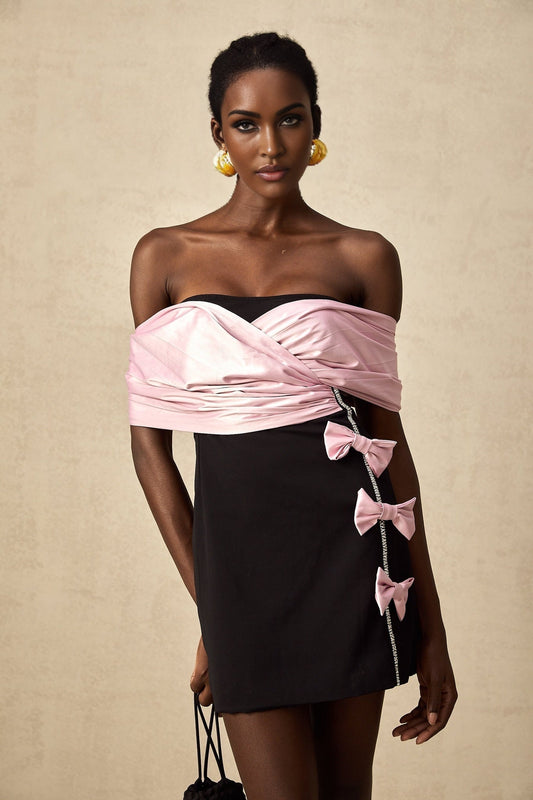 A colorblocked mini dress with a bow embellishment named Doria featuring contrasting colors and a short hemline