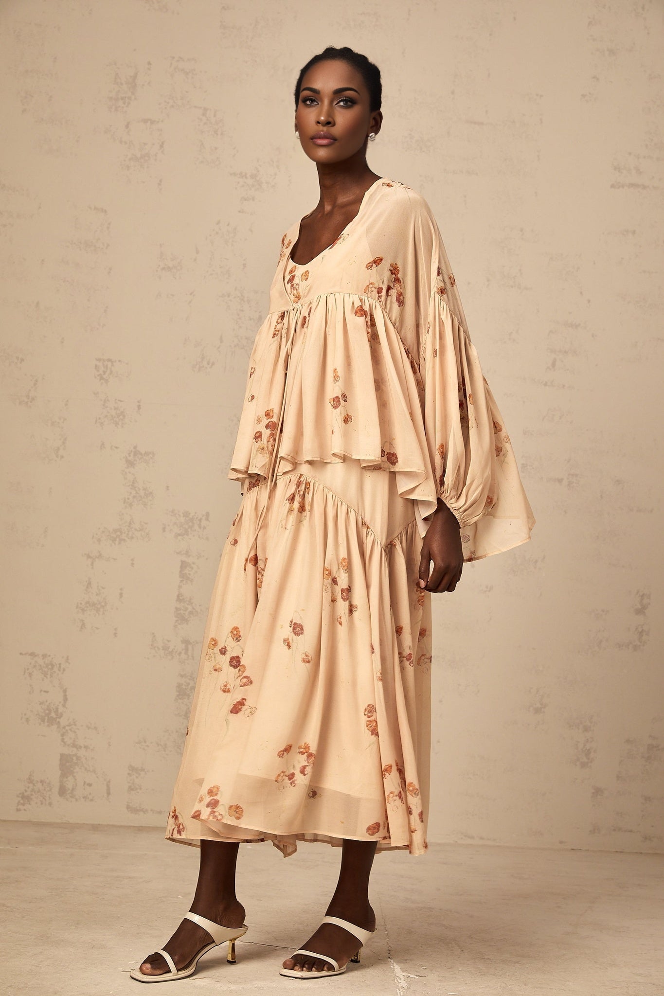A coralpink floral print matching set featuring a pleated blouse and dress with the Maïa brand name visible