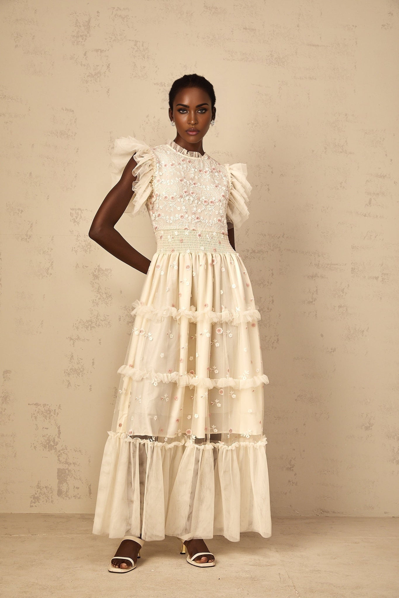 A cream white maxi dress for women with tiered tulle skirt and floral embroidery details