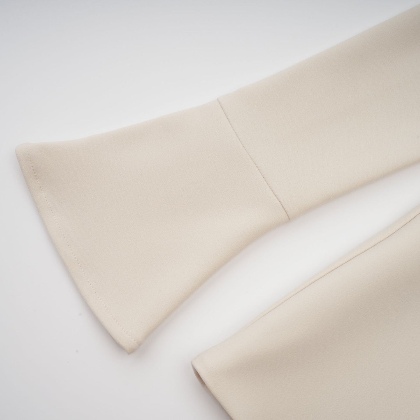 A creamwhite fitted mini dress by Chloé on a plain background