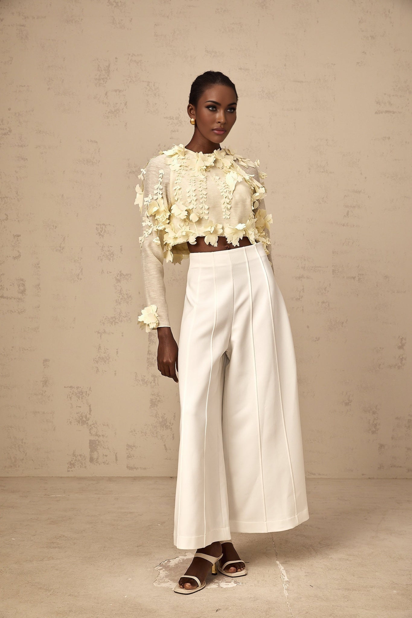 A cropped blouse in light yellow color featuring threedimensional petal details named Rosalie