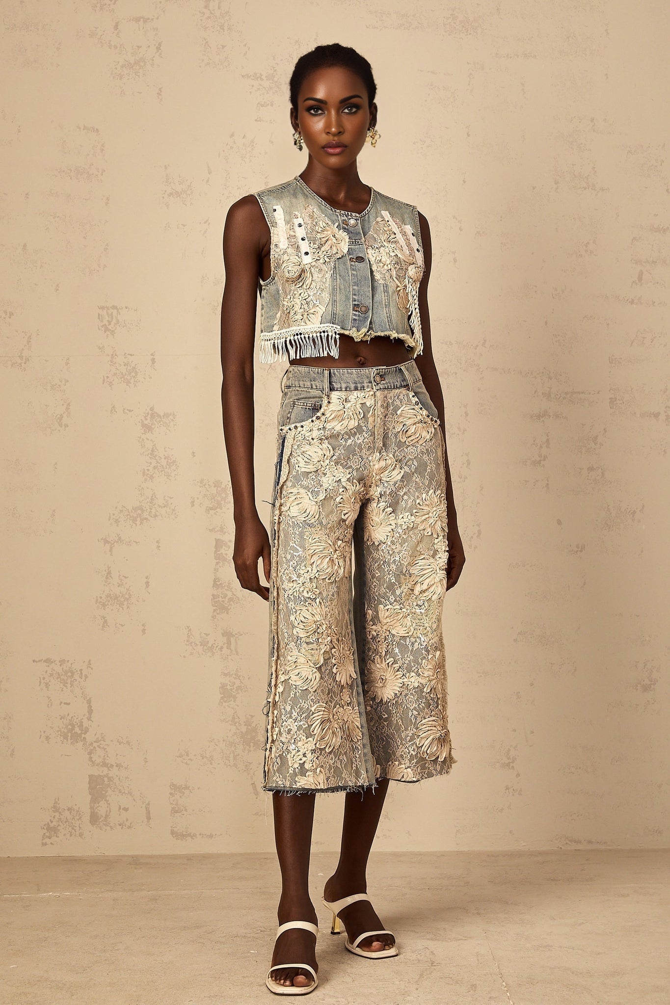 A cropped denim top with blue lace panelling details named Amaryllis featuring a short length and decorative lace inserts