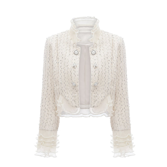 A cropped white jacket with beaded embellishments and ruffle details named Blanche